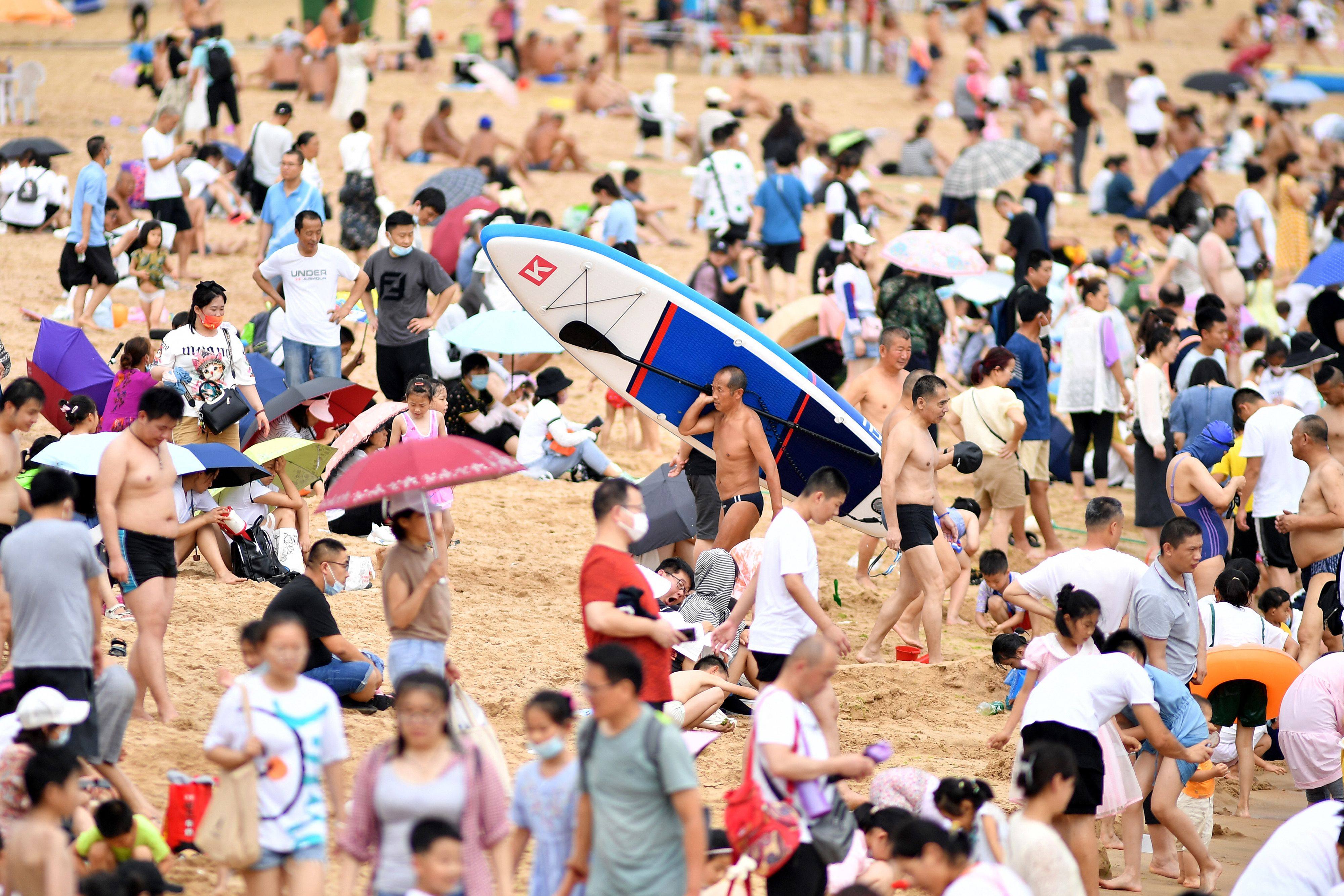 Beachgoers in Qingdao, in China’s eastern Shandong province. Falling birth levels and an ageing population have grave implications for national development. Photo: AFP