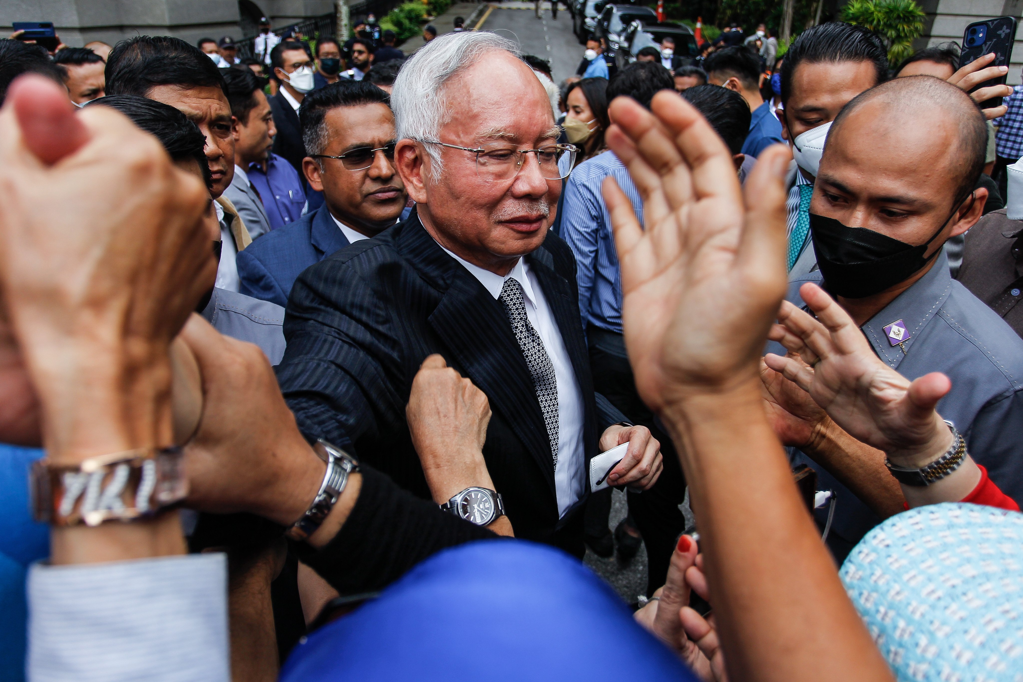 Malaysia’s former prime minister Najib Razak (centre) greets his supporters outside the Federal Court in Putrajaya on August 23. Photo: EPA-EFE