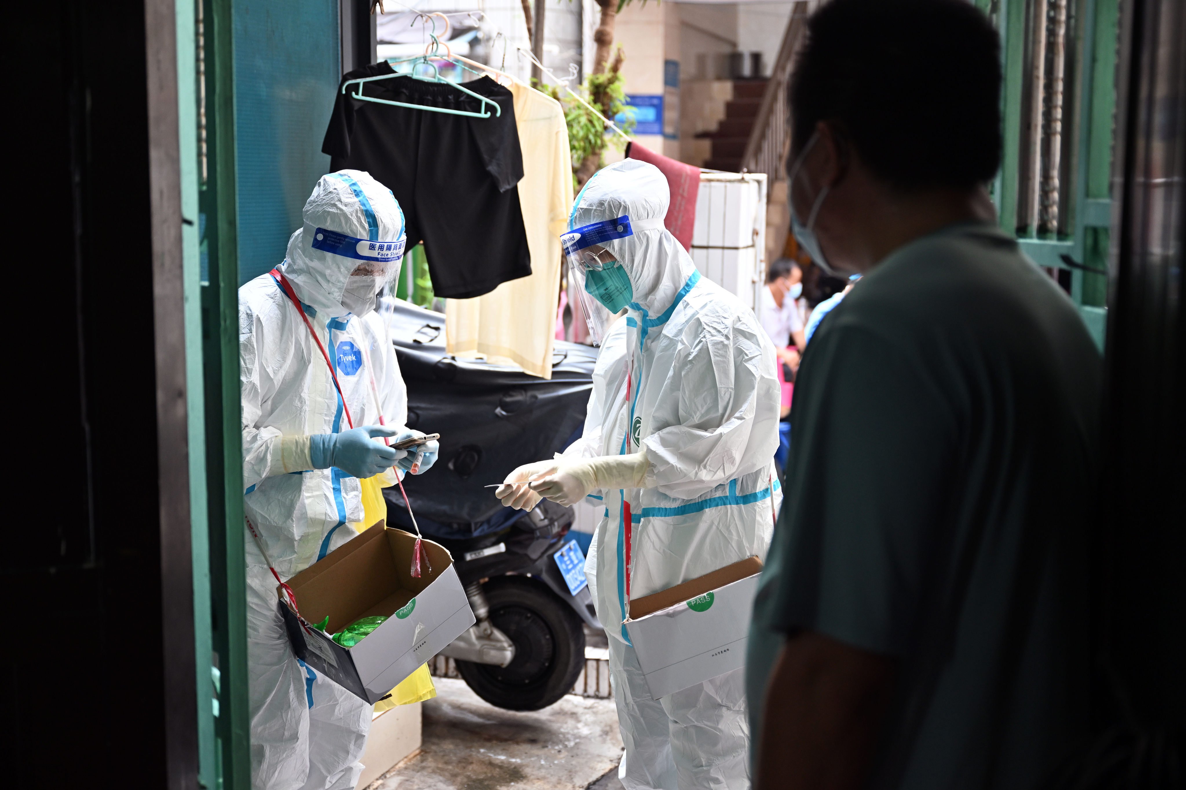 Medical workers go door-to-door in Sanya, Hainan province, to take swab samples for Covid-19 testing amid the city’s lockdown earlier this month. Photo: Xinhua