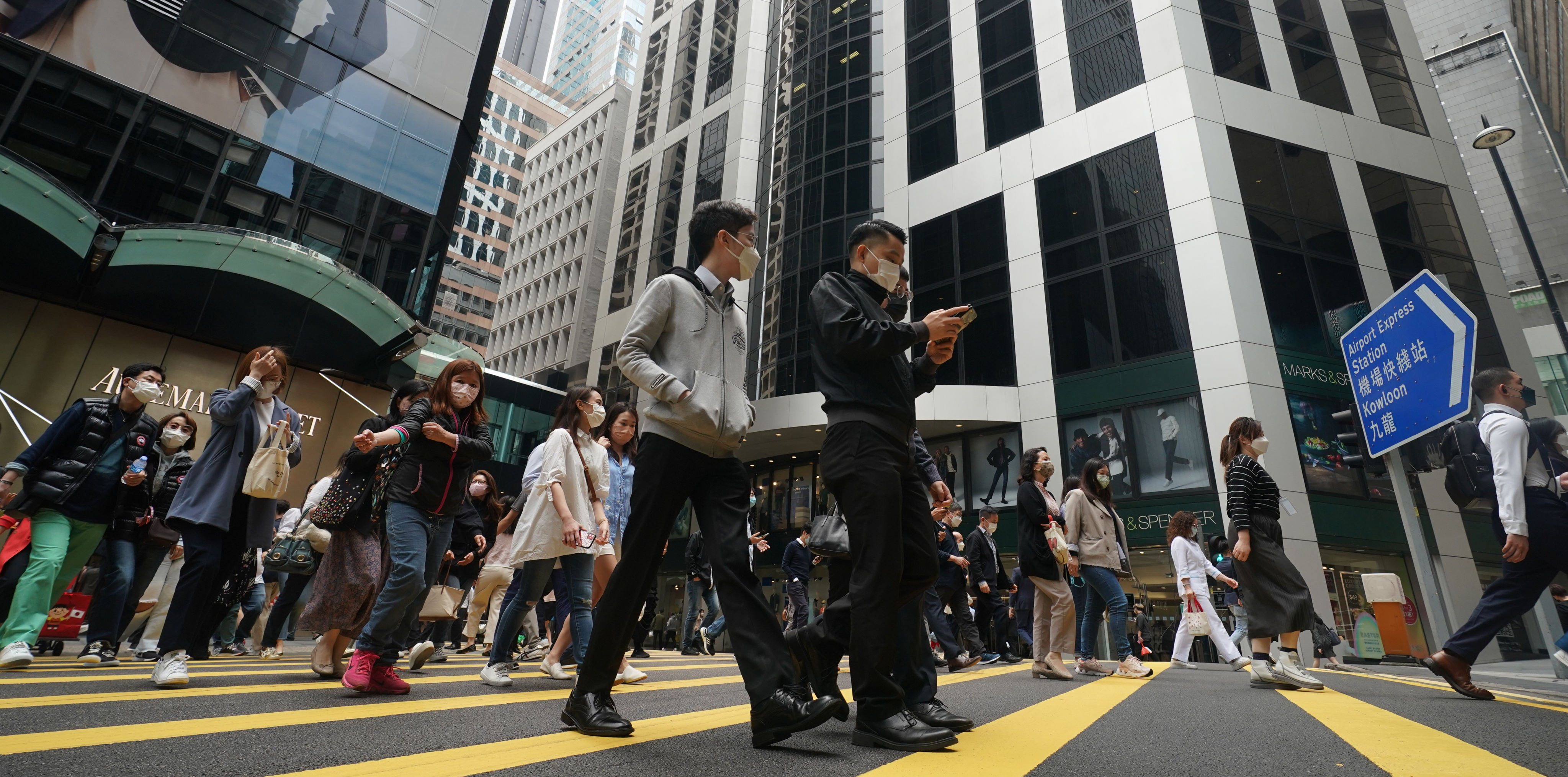 People cross the road in Hong Kong’s Central district on March 30. If we want our workplace to reflect the diversity in society, our hiring practices must keep up. Photo: Felix Wong
