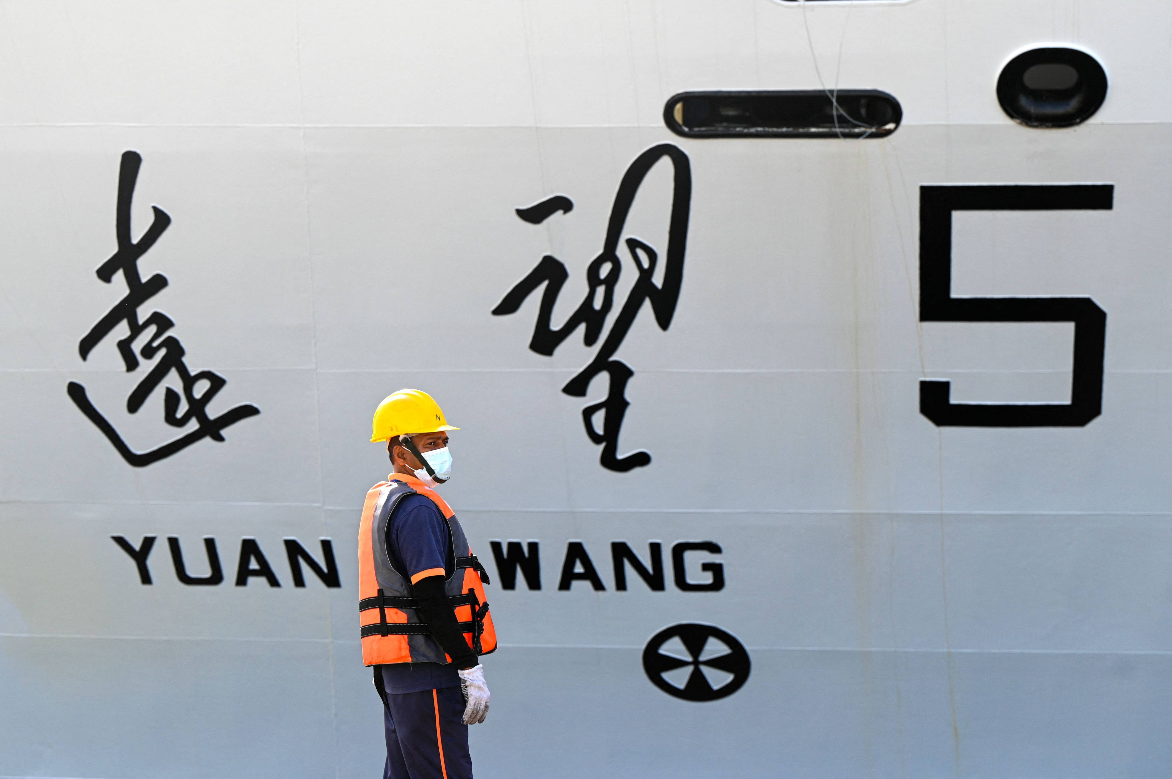 A worker stands alongside China’s research and survey vessel, the Yuan Wang 5, on its arrival at Hambantota port in Sri Lanka on August 16. Photo: AFP