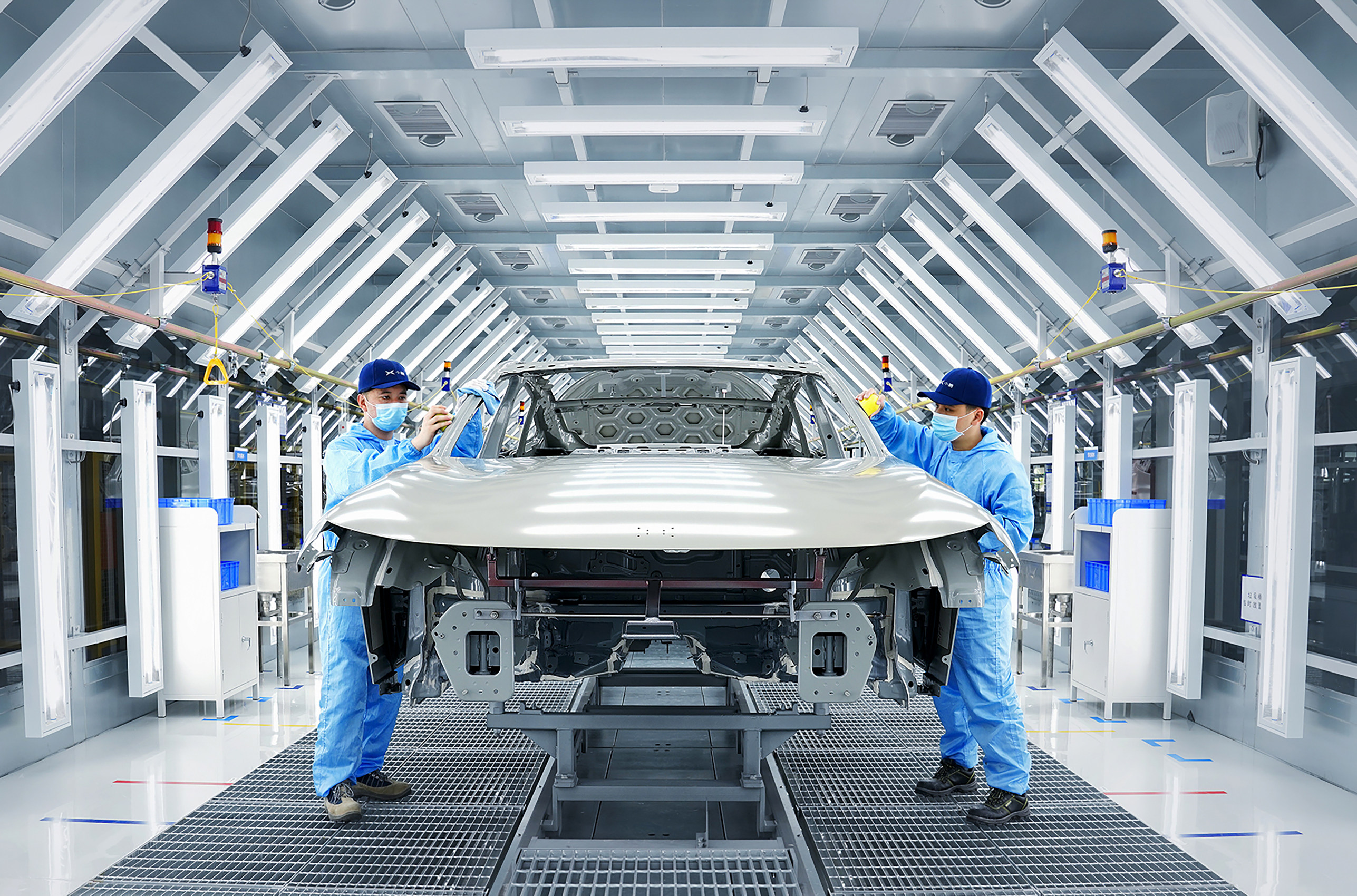 Workers assembling an XPeng EV inside a smart manufacturing factory. Photo: Handout