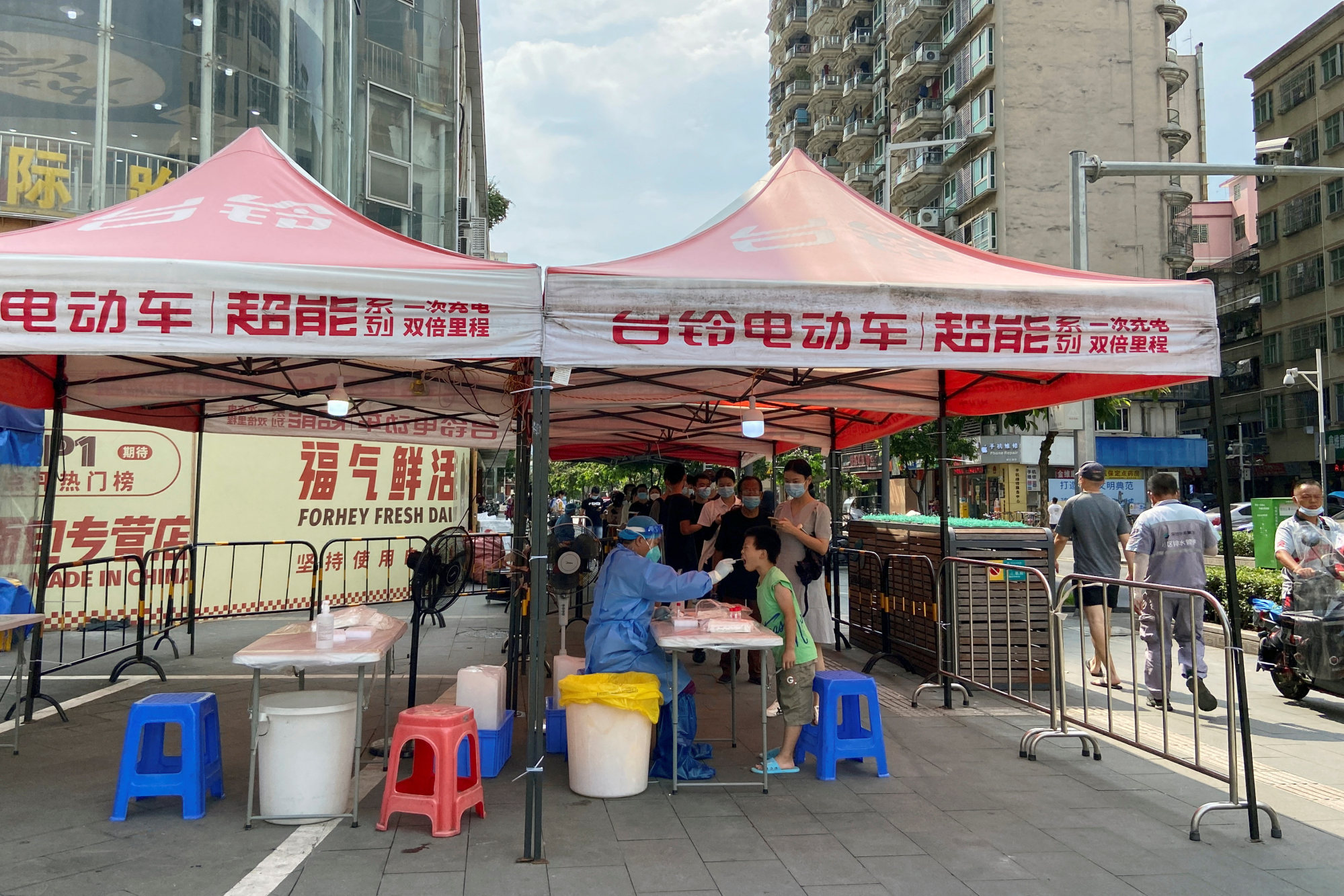 A medical worker collects a swab from a resident at a nucleic acid testing site in Shenzhen on Monday, as the city tries to contain a fresh outbreak. Photo: Reuters