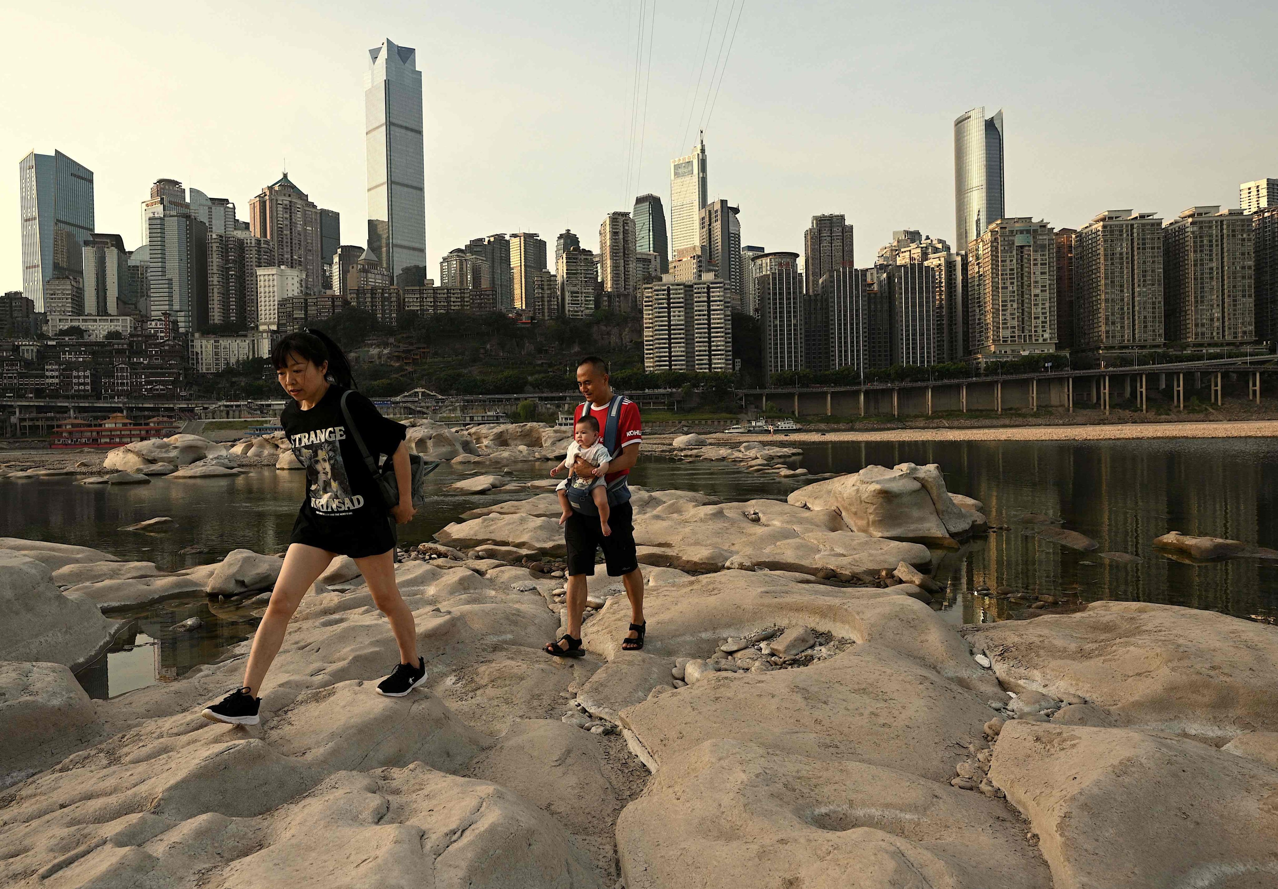 People walk over the dried-up riverbed of the Jialing, a tributary of the Yangtze, in Chongqing. Photo: AFP