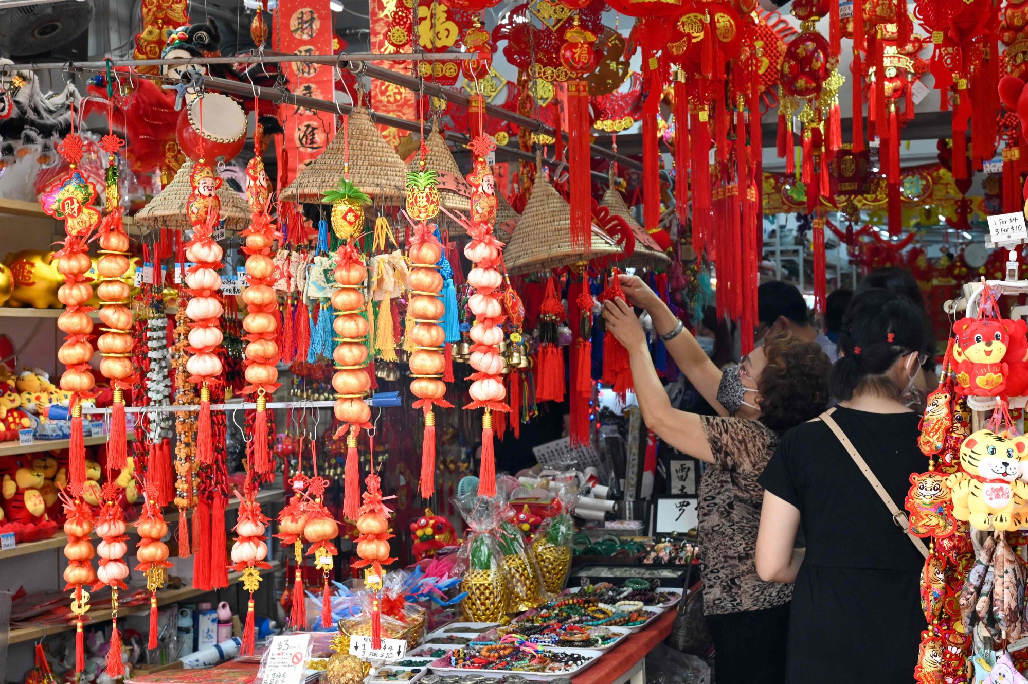 A woman looks at decorative ornaments on the eve of Lunar New Year at the Chinatown district in Singapore in January 2022. Photo: AFP