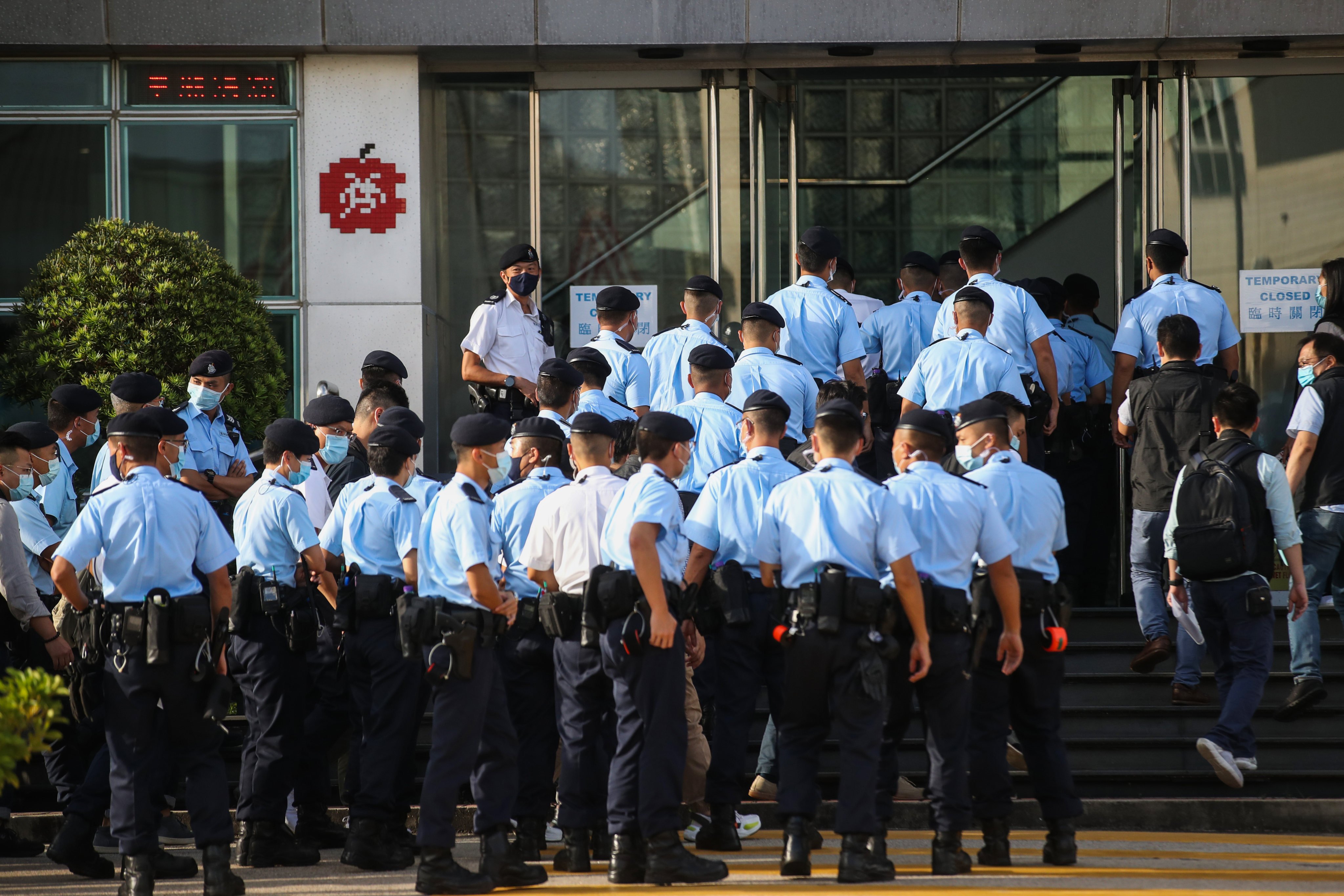 Police officers gather at the Next Digital building in Tseung Kwan O last year. Photo: Winson Wong