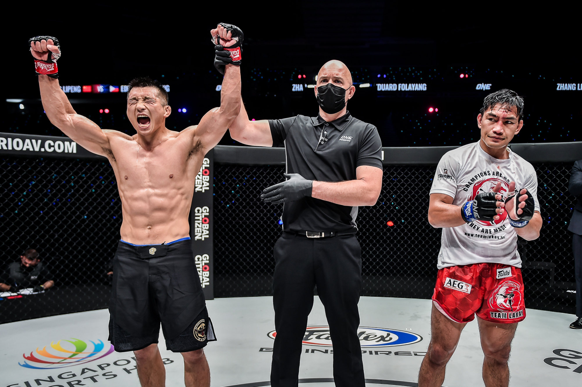 Zhang Lipeng celebrates a decision victory over Eduard Folayang.