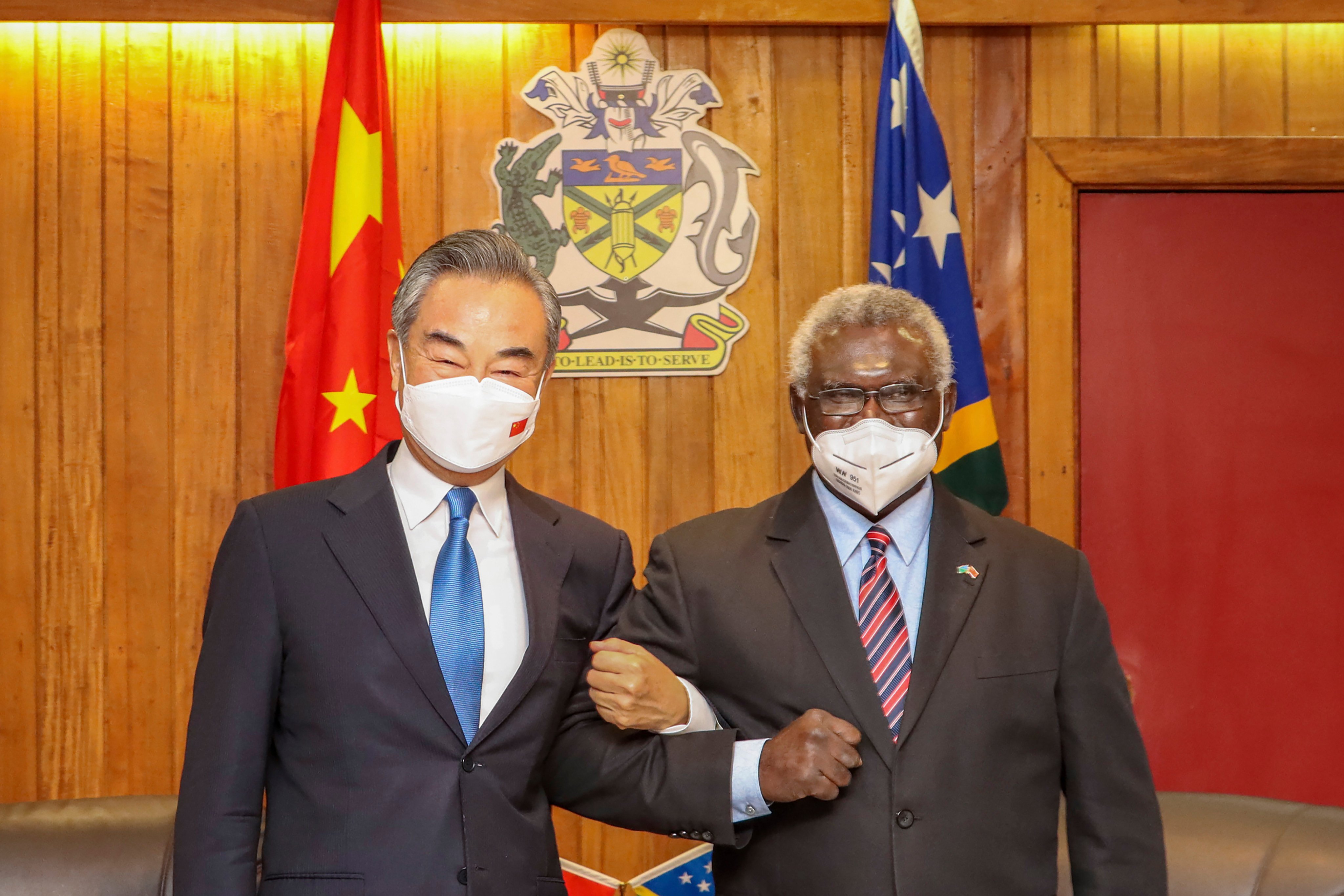 Solomon Islands Prime Minister Manasseh Sogavare, right, locks arms with visiting Chinese Foreign Minister Wang Yi in Honiara earlier this year. Photo: Xinhua