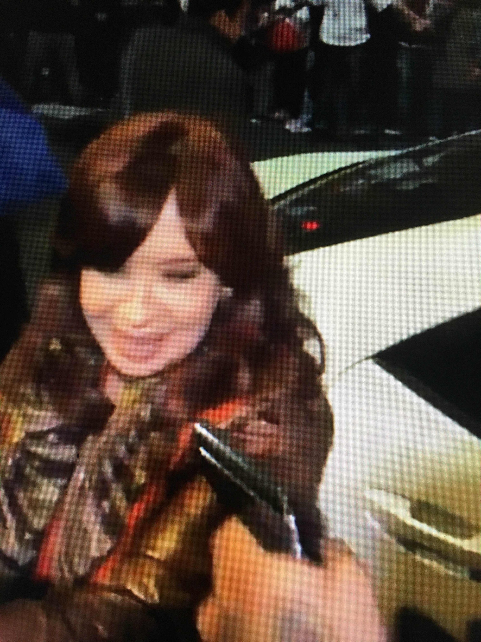 A man points a gun at Argentina’s Vice-President Cristina Fernandez de Kirchner as she arrives at her residence in Buenos Aires. Photo: TELAM / AFP