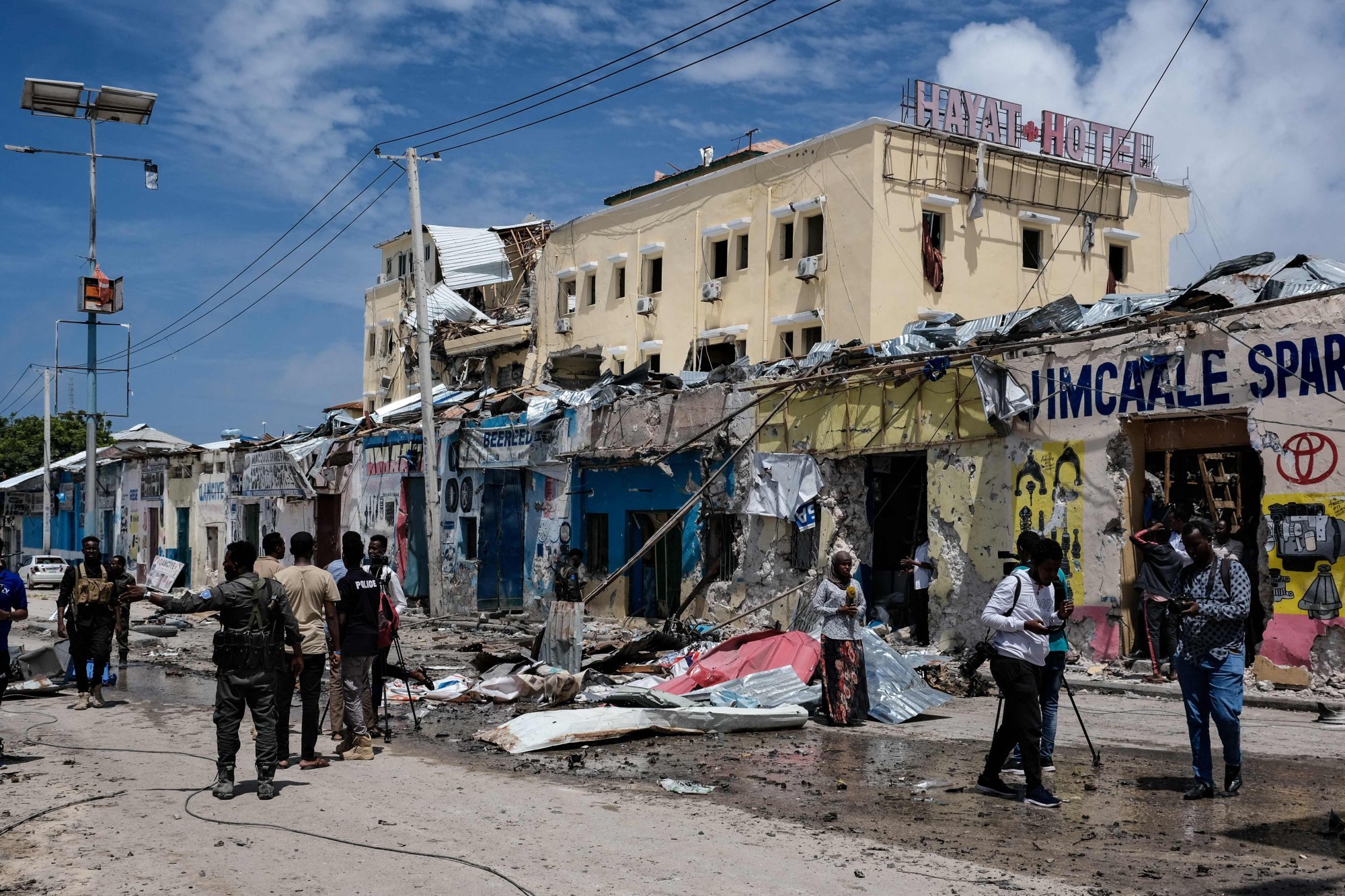 Media in front of destroyed building after a deadly 30-hour siege by al-Shabab jihadists, an al-Qaeda-linked group, at Hayat Hotel in Mogadishu, Somalia on August 21, 2022. At least 13 civilians lost their lives and dozens were wounded in the gun and bomb attack. Photo: AFP