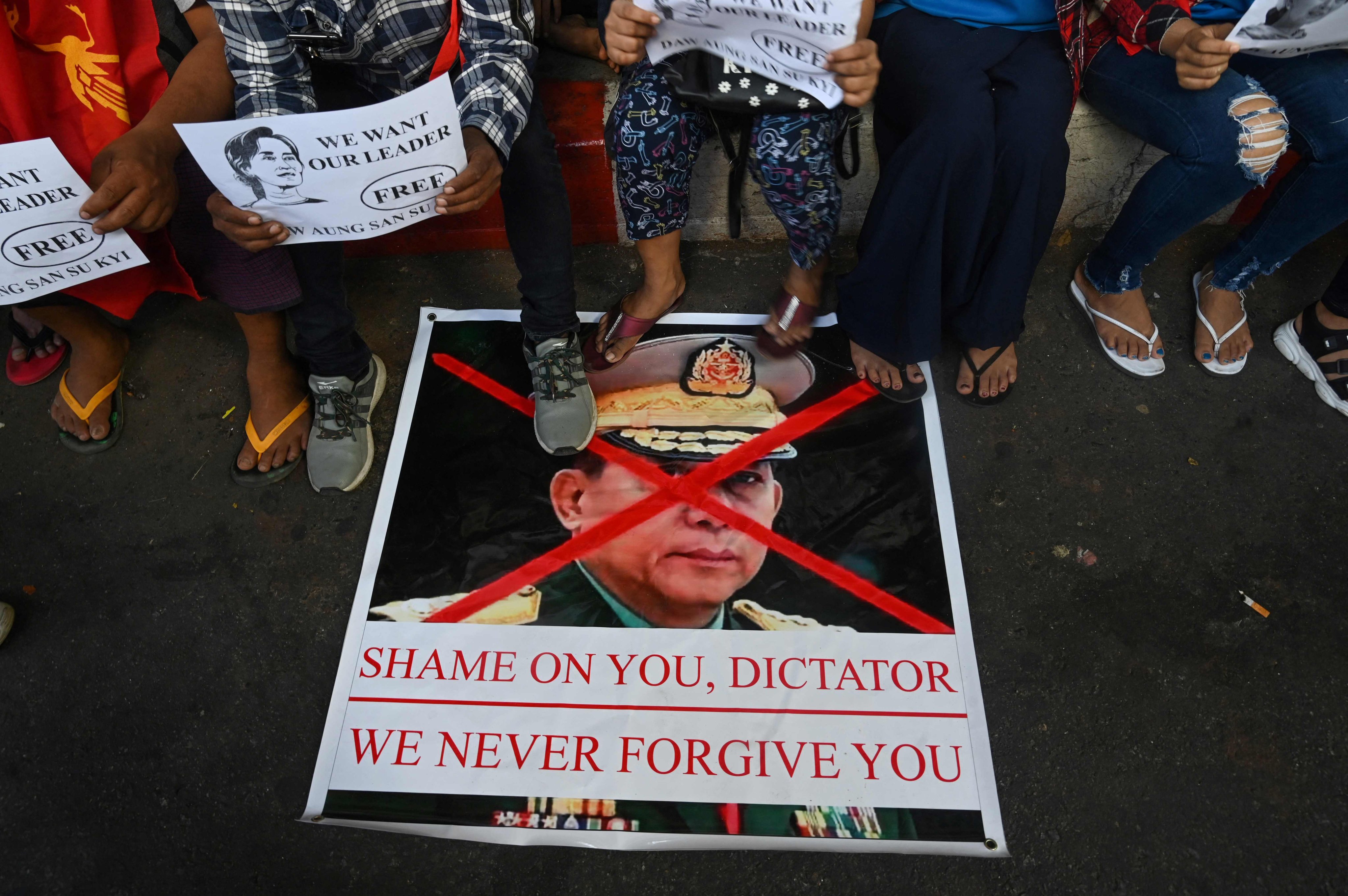 Pprotesters step on a banner showing an image of Myanmar military chief Senior General Min Aung Hlaing during a demonstration against the military coup in Yangon. Photo: AFP