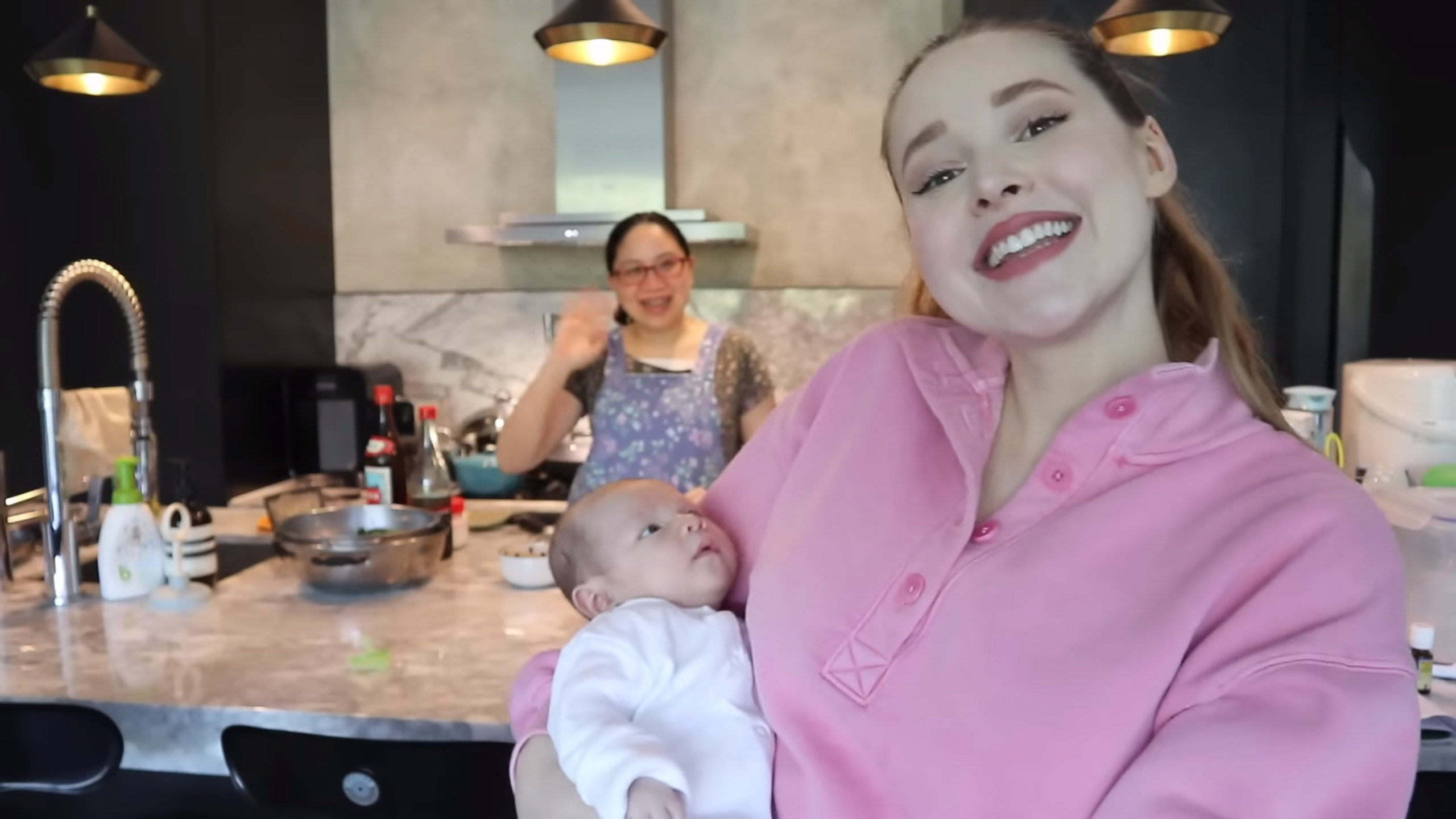 Carol Chan (left), a confinement nanny, together with Taylor Richards. Richard vlogged about her experience undergoing a month of Chinese confinement after giving birth. Photo: YouTube/@Taylor R