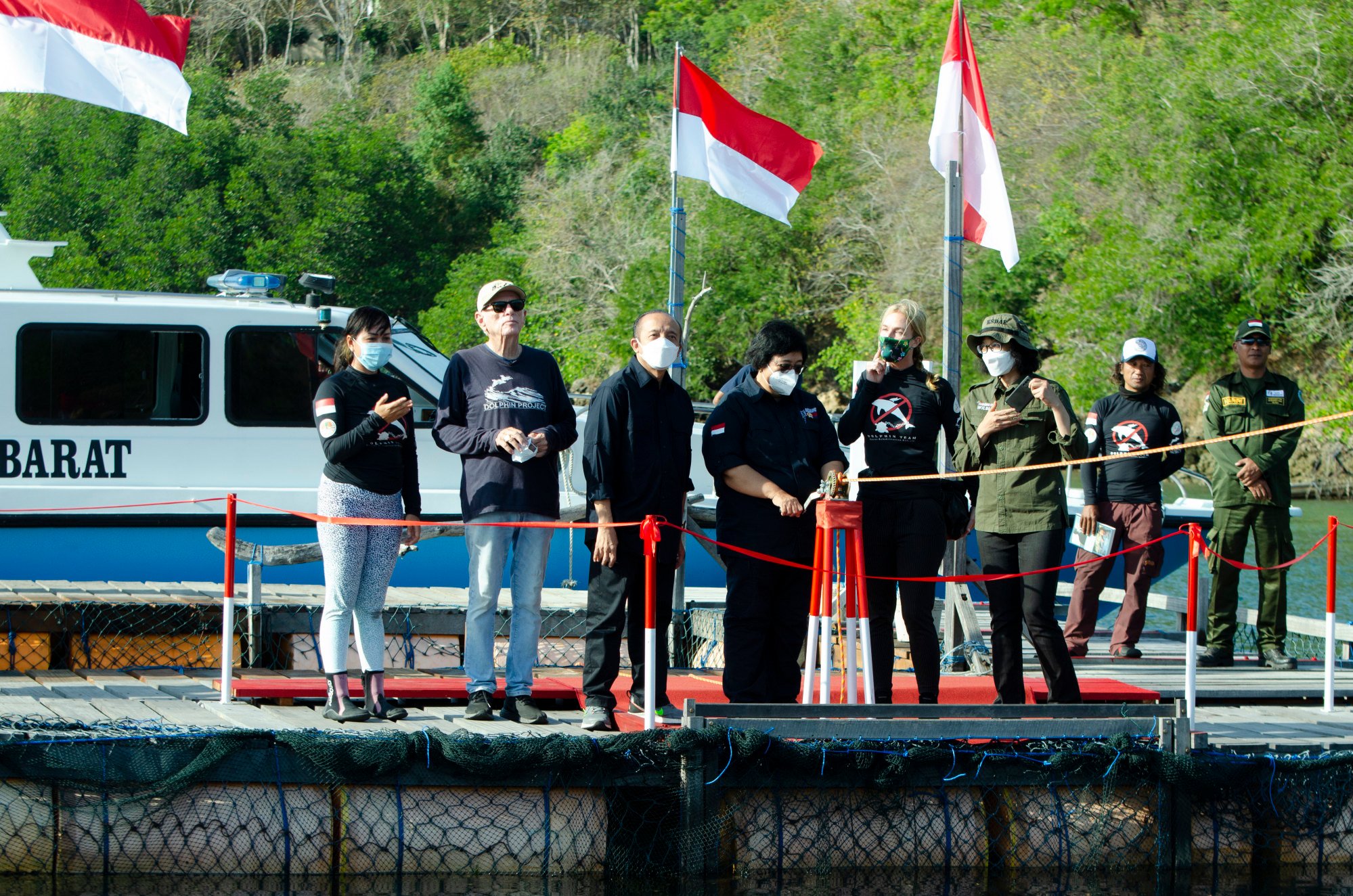 Indonesian Environment and Forestry Minister Siti Nurbaya Bakar, centre, opens the gates to release rescued dolphins Rocky, Rambo and Johnny back into the wild in on Saturday. Photo: DolphinProject.com via AP