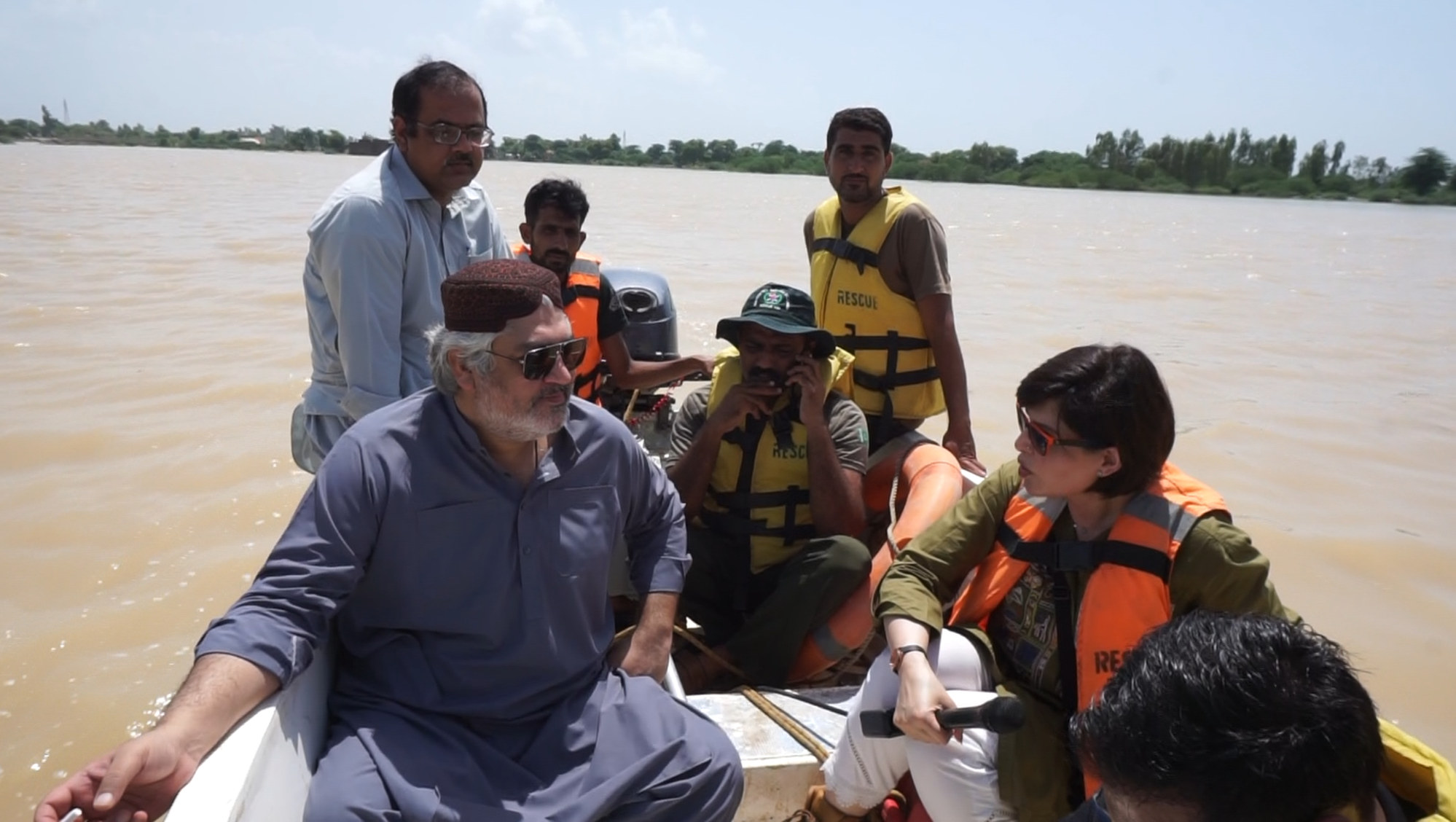 Pakistani MP Muhammad Khan Leghari talks to TV presenter Zunaira Azhar as he tours his inundated constituency in central Pakistan with a government rescue team. Photo: Salman Farooque