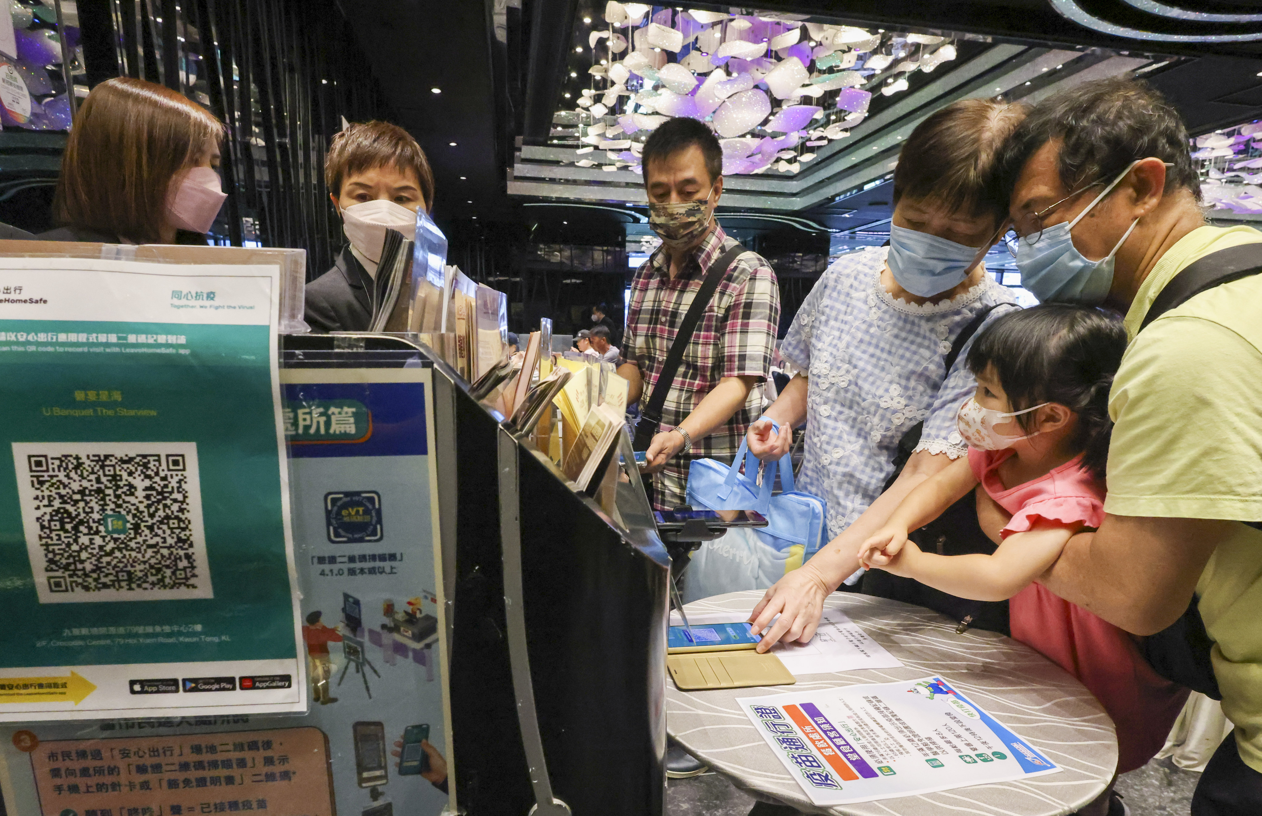 Patrons scanning the ‘Leave Home Safe’ app to enter a restaurant. Hong Kong will extend this measure to children as young as five. Photo: Dickson Lee