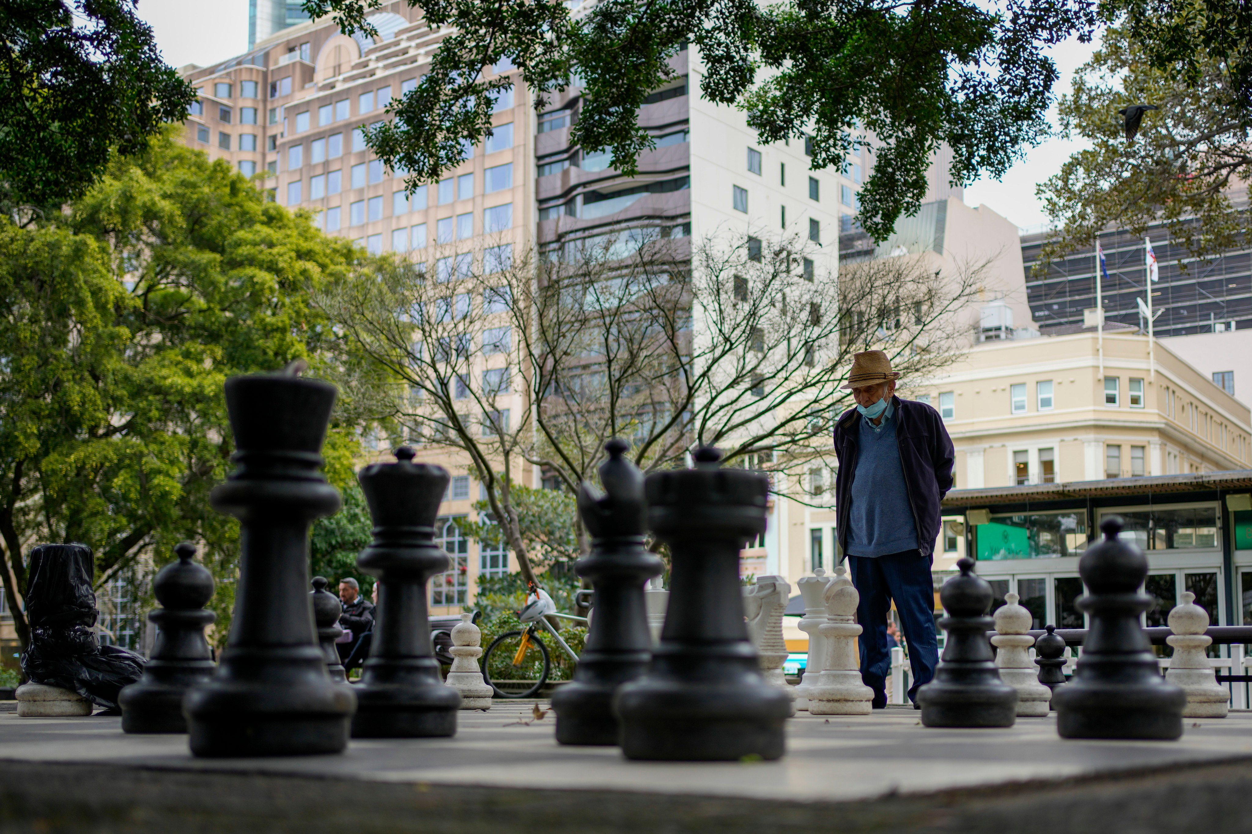 A man contemplates his next move as he plays chess in Hyde Park Sydney, Australia, on August 11. In the current chess match among central banks, the US Federal Reserve’s ability to shape the global policy context makes it the grandmaster. Photo: AP