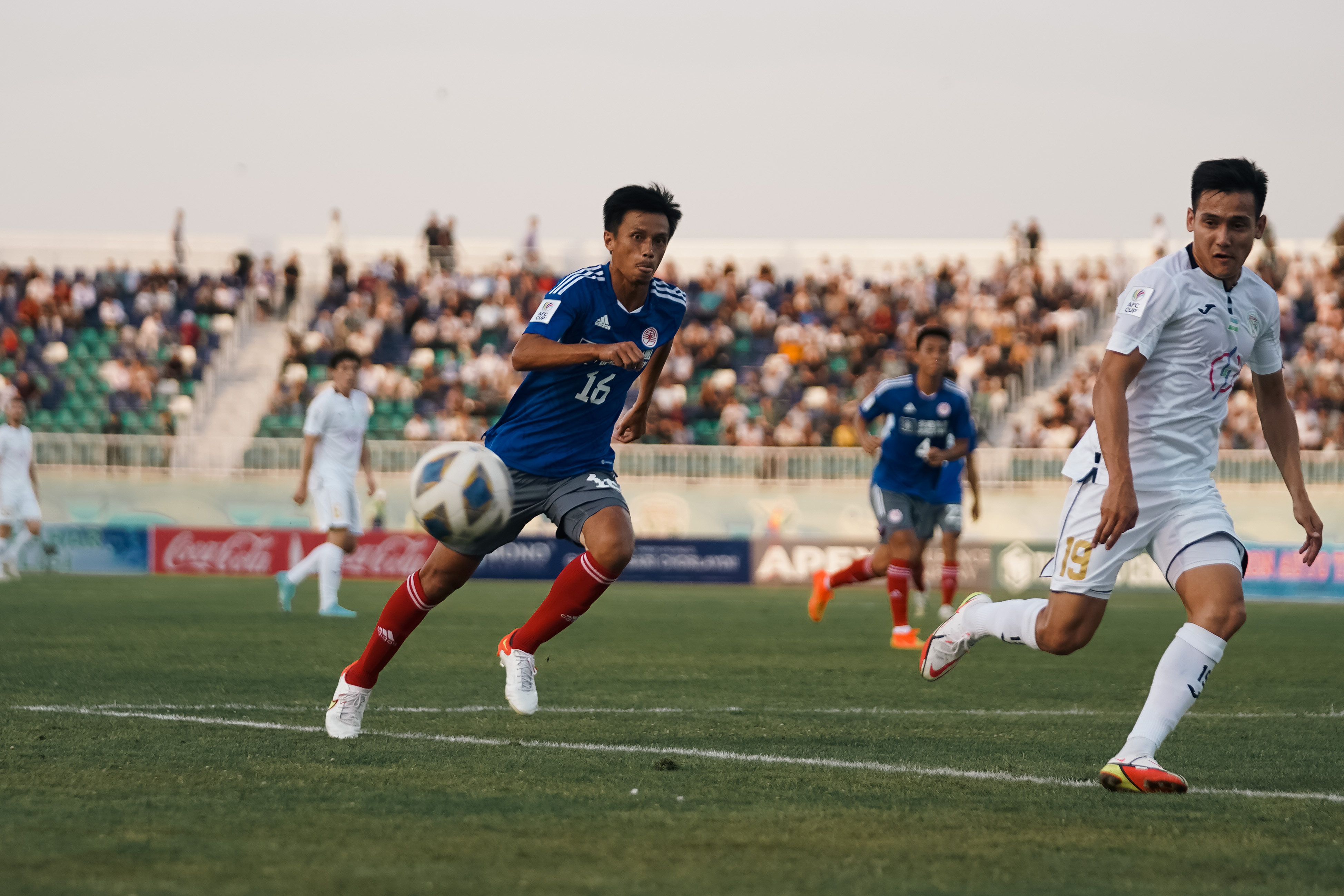 Eastern Long Lions midfielder Leung Chun-pong (left) gives chase as PFC Sogdiana striker Javokhir Kakhramonov waits to get the ball during the first half of the AFC Cup inter-zone semi-final. Photo: Eastern SC 