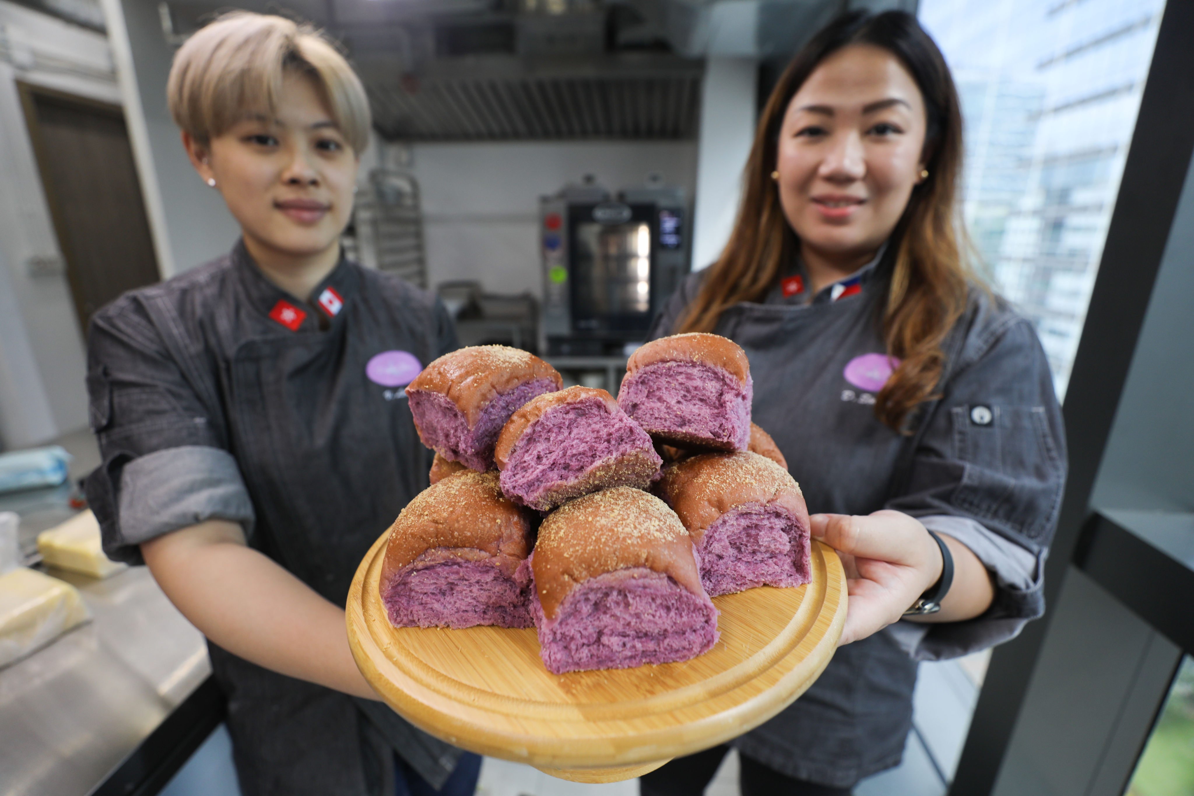 Veronica Leung (left) and Esther Claudine Lim Singzon, founder of bakery Purple Flour Hong Kong, with a plate of ube pandesal. Photo: Xiaomei Chen