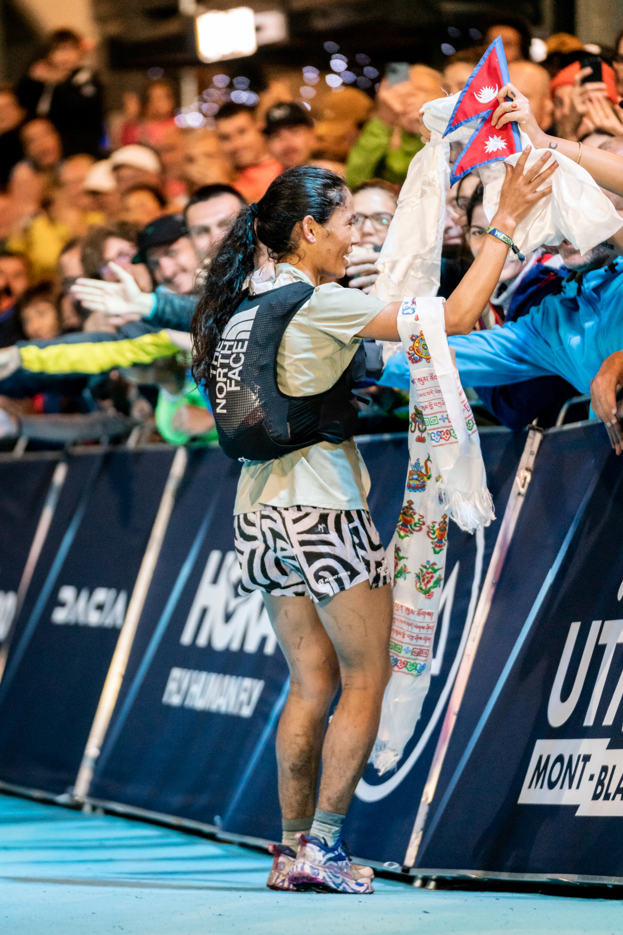Sunmaya Budha celebrates with fans after coming second at the UTMB CCC despite an Achilles injury.