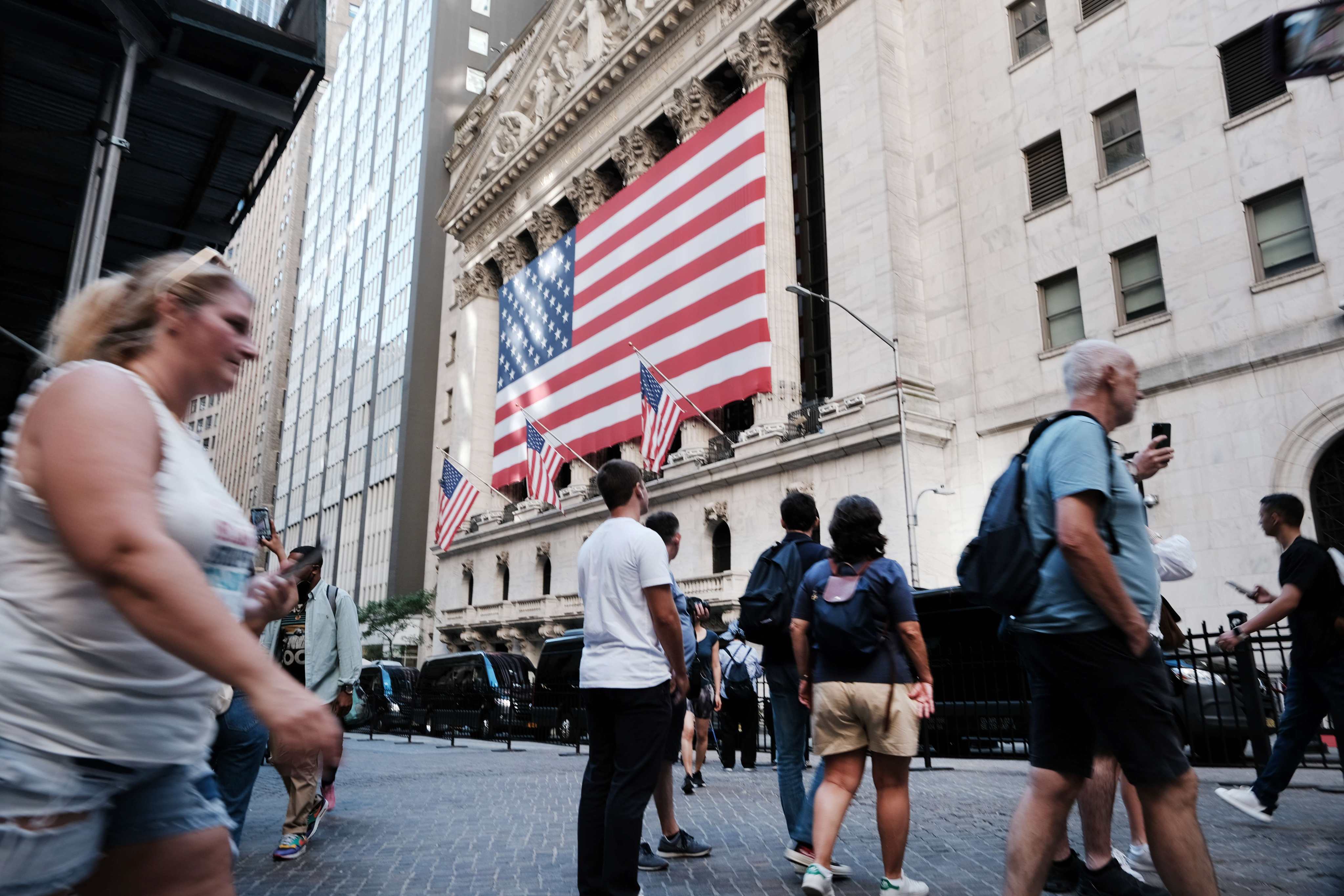People walk past the New York Stock Exchange on September 1. US core inflation remains high, at close to 6 per cent. Photo: AFP