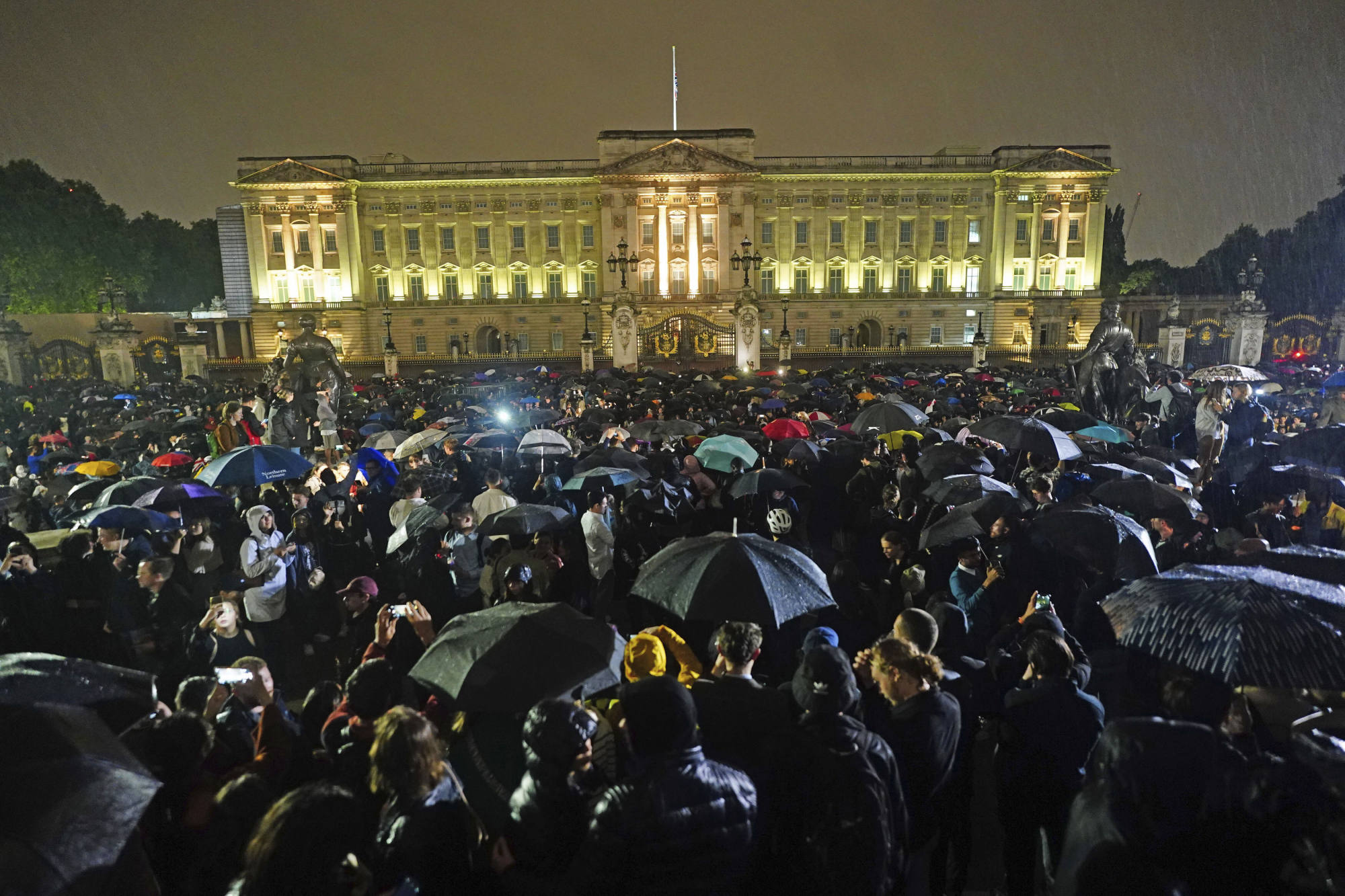 People gather outside Buckingham Palace following the announcement of the death of Queen Elizabeth. Photo: AP