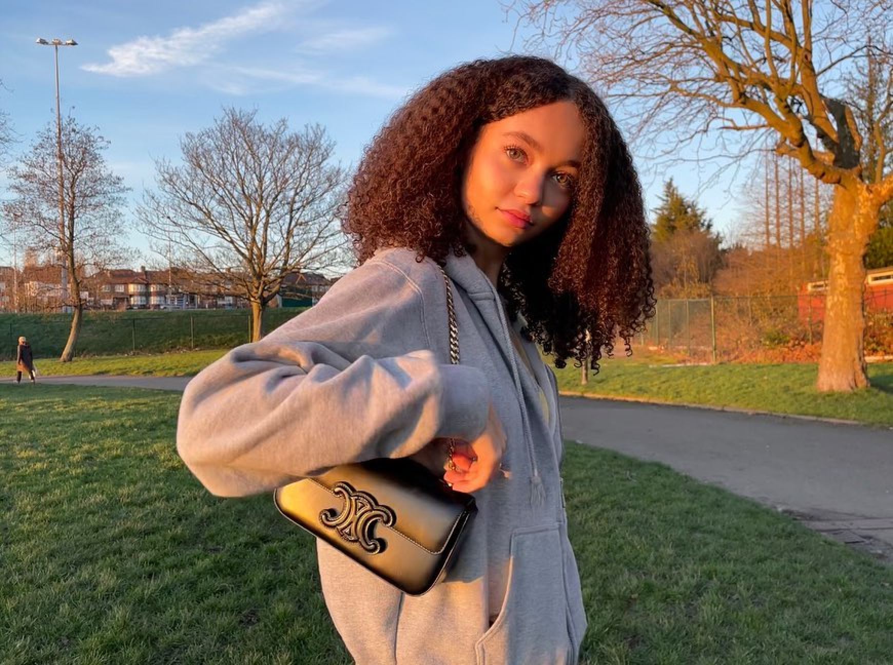 Nico Parker poses with a Celine bag but keeps it casual with an oversized sweatshirt in her local park. Photo: @nicoparkerofficial/Instagram