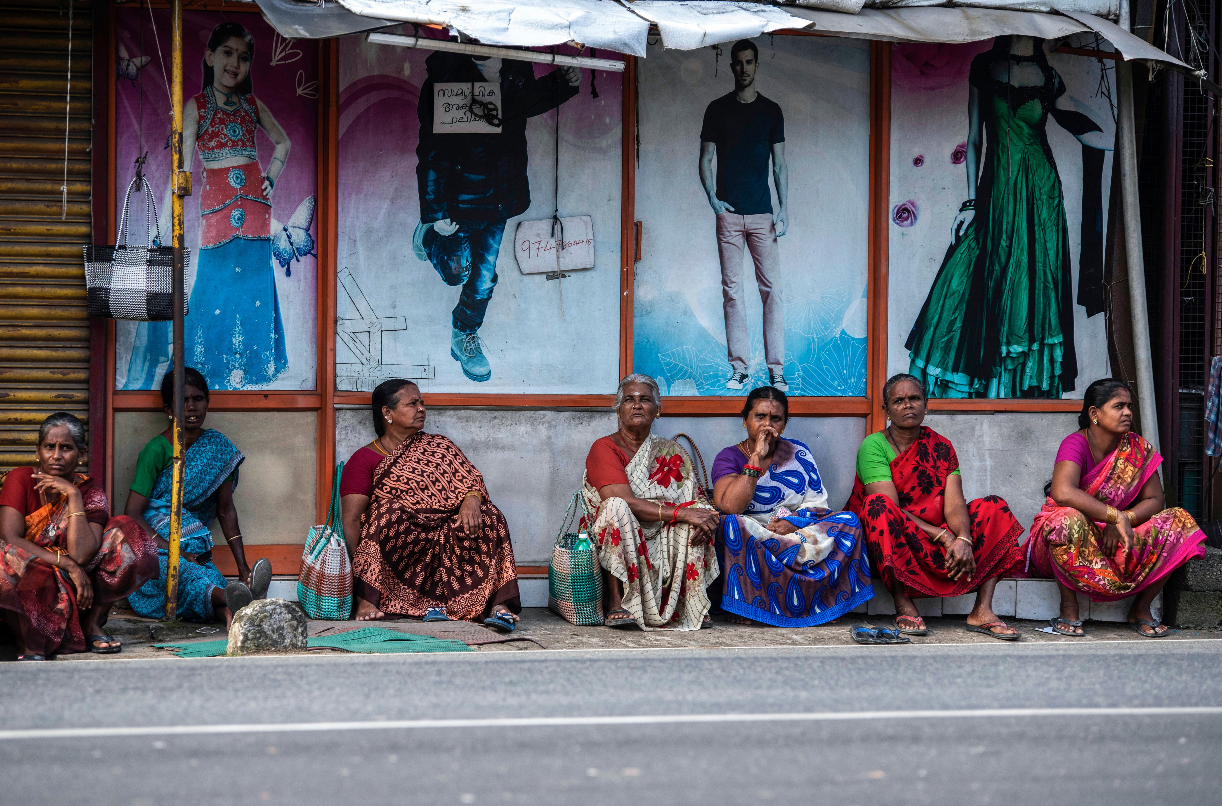 Women sit by a roadside in the morning in anticipation of daily-wage jobs in Kochi, in the southern Indian state of Kerala, on August 10. Even as the pandemic gradually abates, allowing room for a return to some form of business as usual, the pace of recovery has been slower for women. Photo: AP