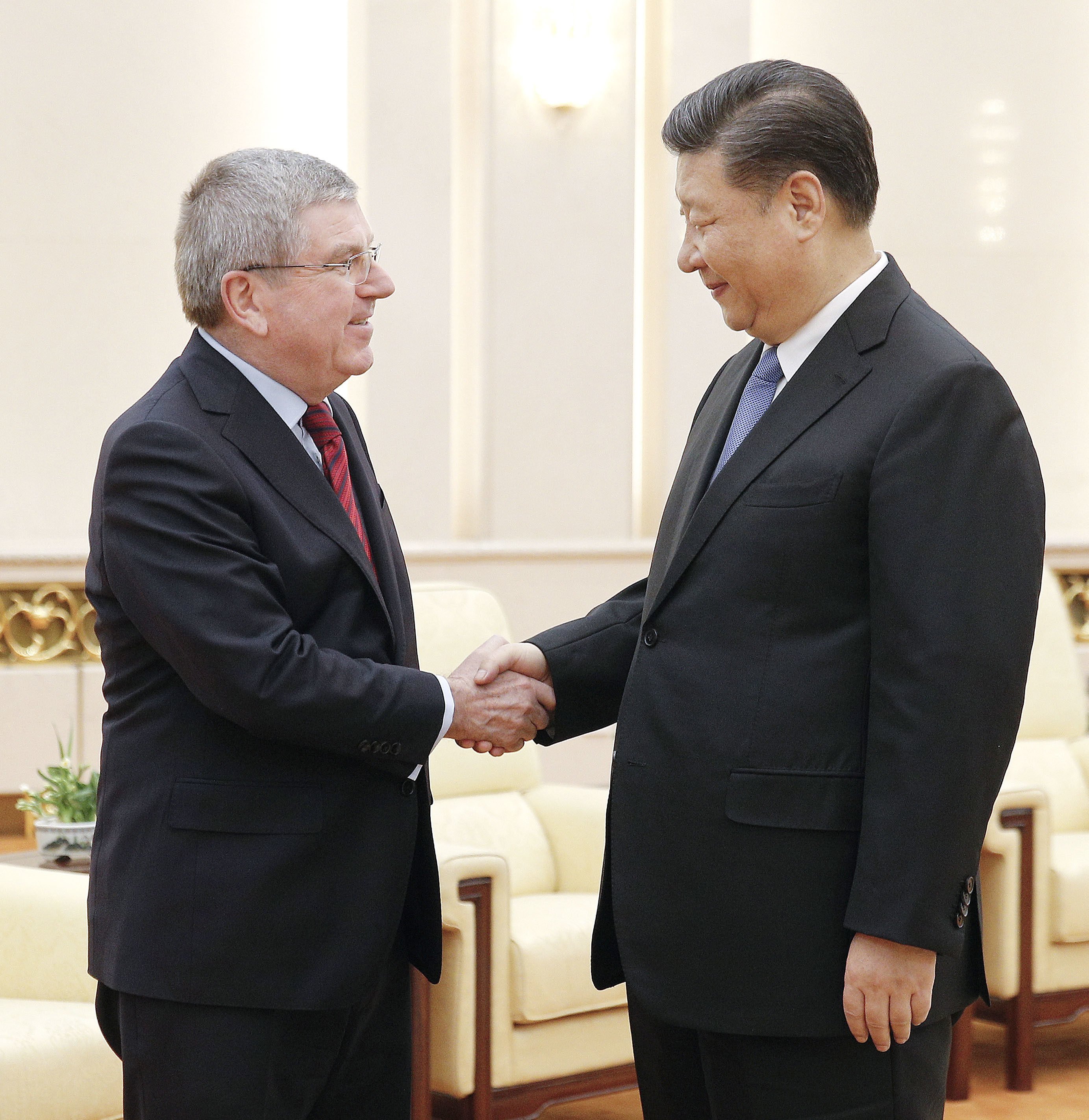 International Olympic Committee president Thomas Bach (left) and Chinese President Xi Jinping shake hands before their talks at the Great Hall of the People, ahead of the 2022 Beijing Winter Games. Photo: Kyodo