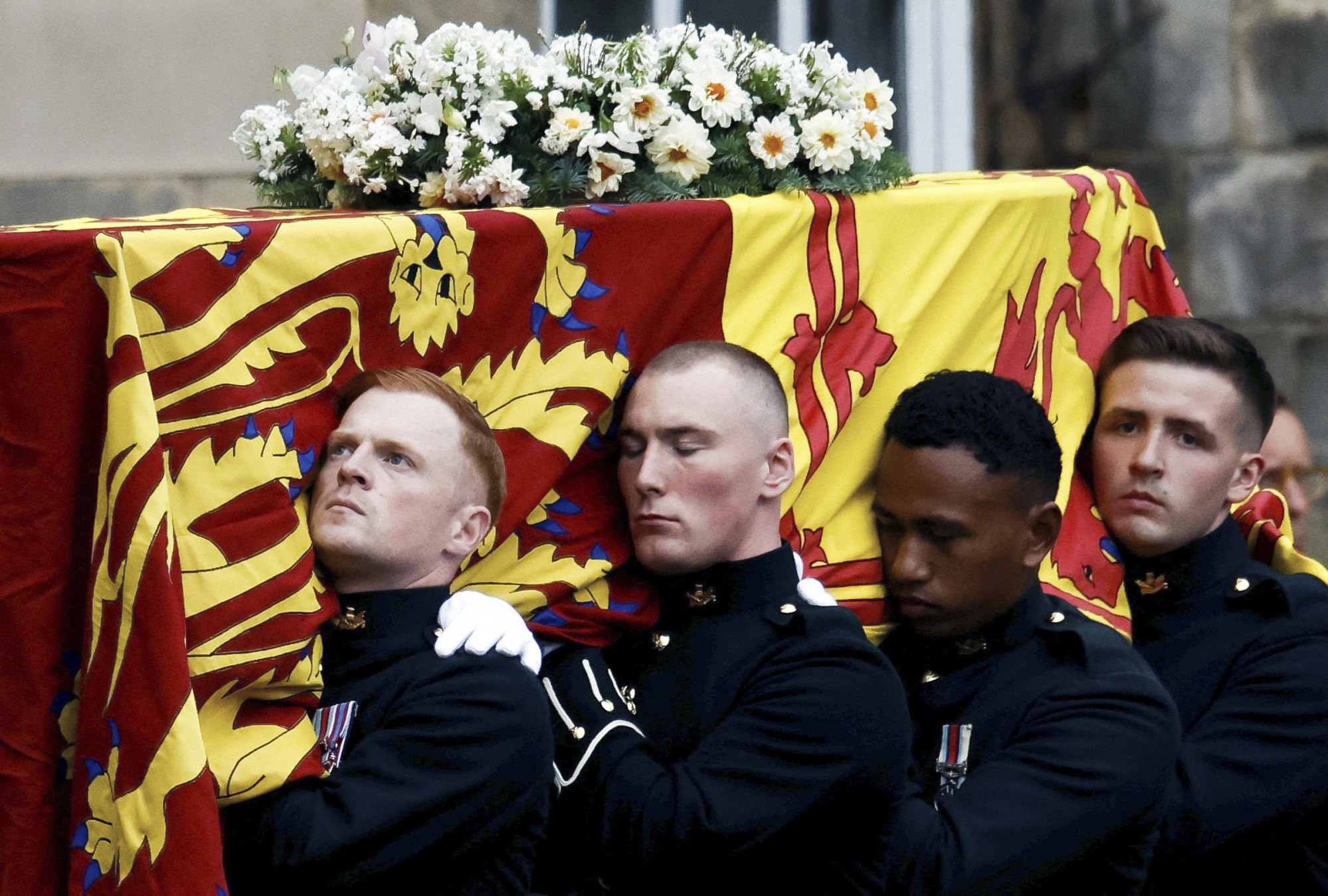 Pallbearers carry the coffin of Queen Elizabeth, as it arrives at Holyroodhouse, where it will lie in rest for a day, in Edinburgh. Photo: AP