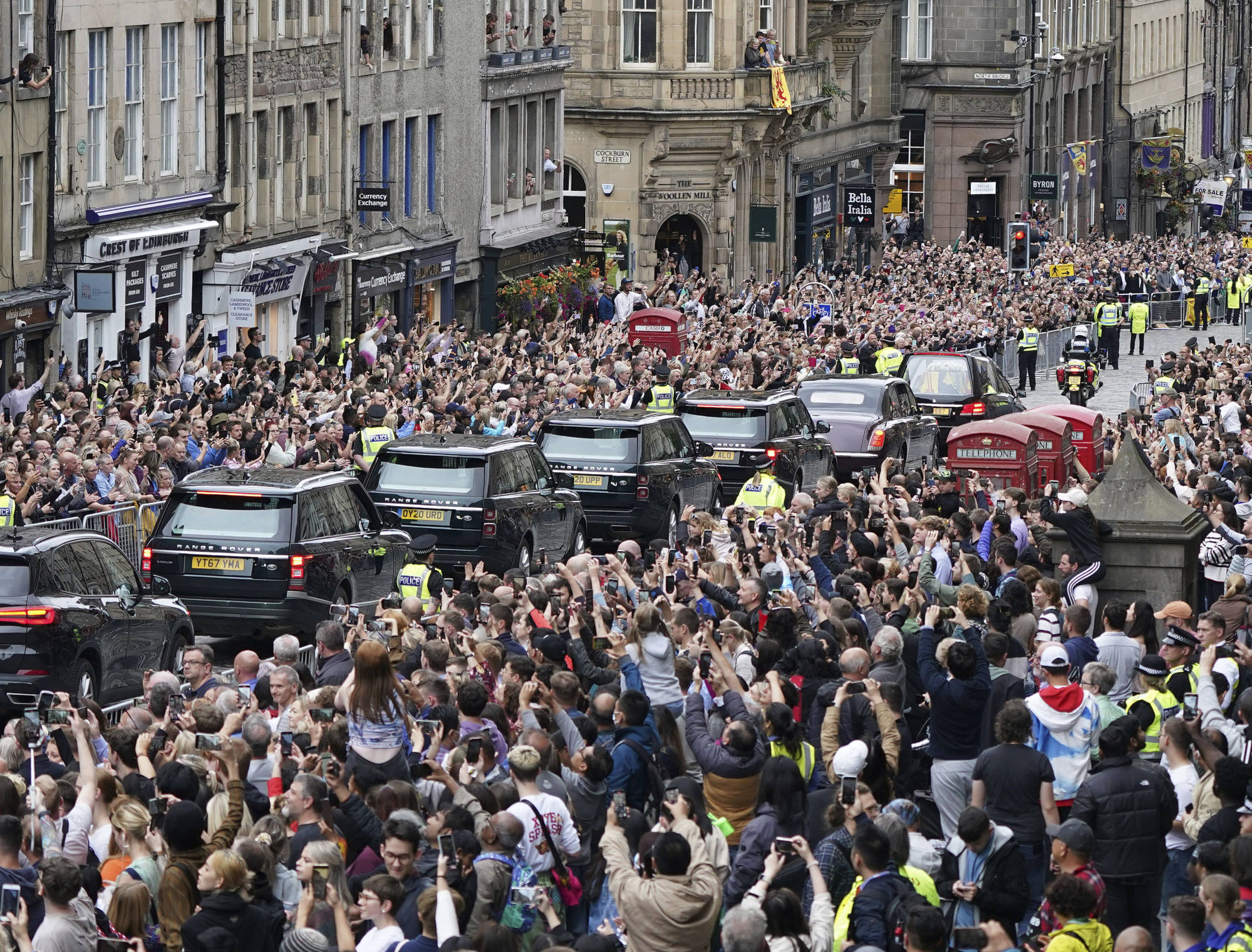 Crowds watch as the hearse carrying the coffin of Queen Elizabeth, passes Mercat Cross in Edinburgh. Photo: AP