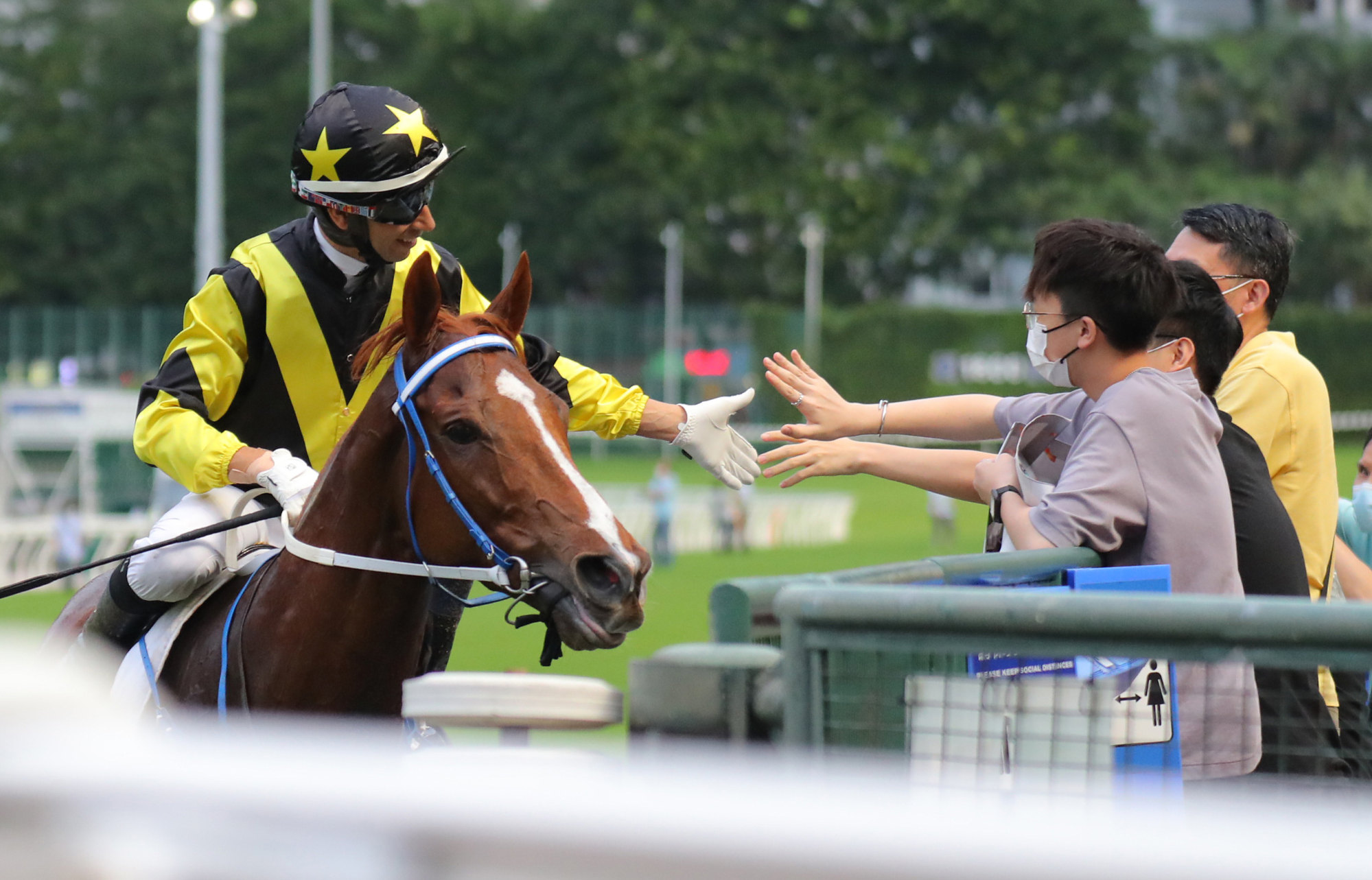 Joao Moreira high fives fans.