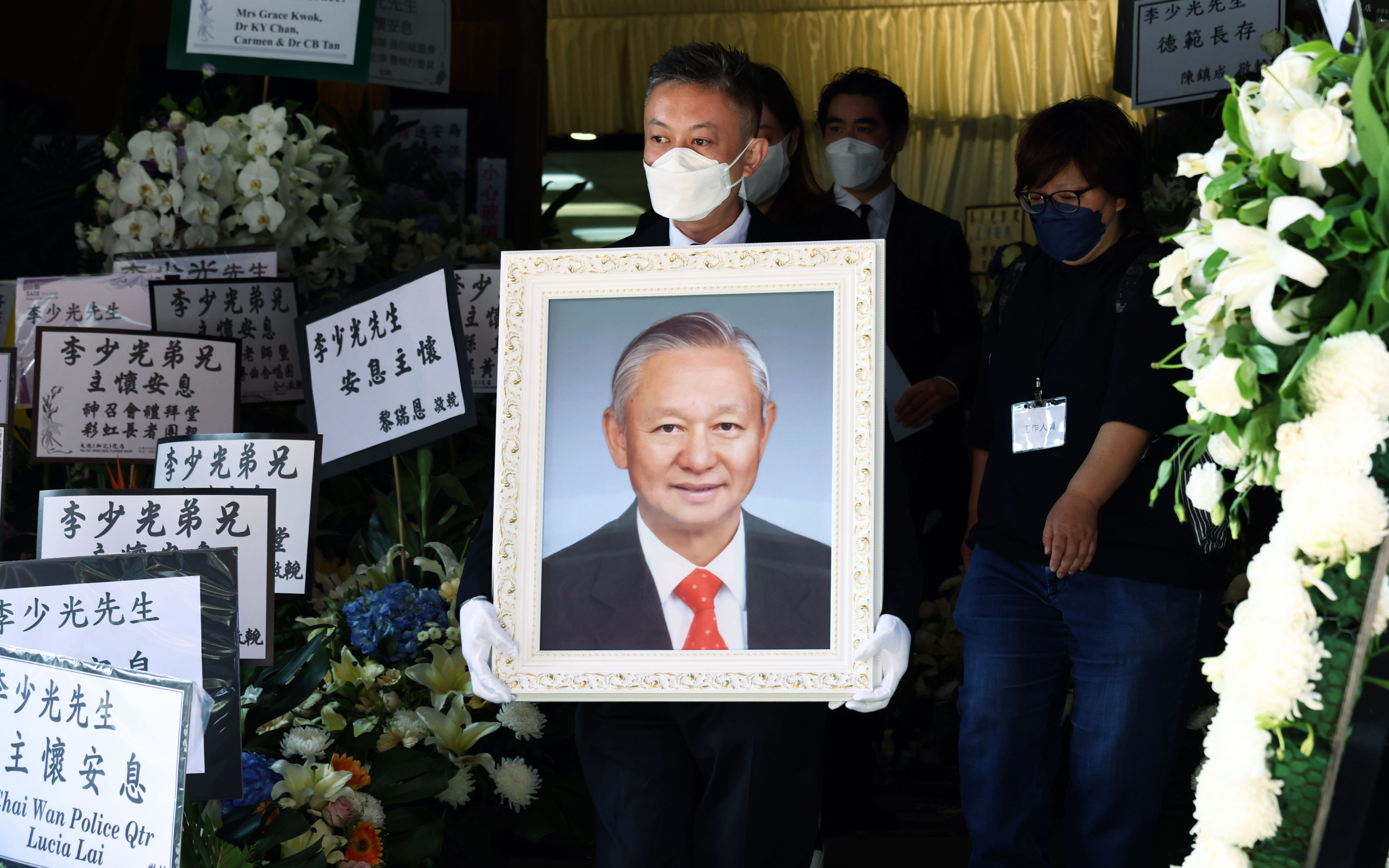 Glen Lee holds a portrait of his father Ambrose Lee at the funeral in  Hung Hom. Photo: Dickson Lee
