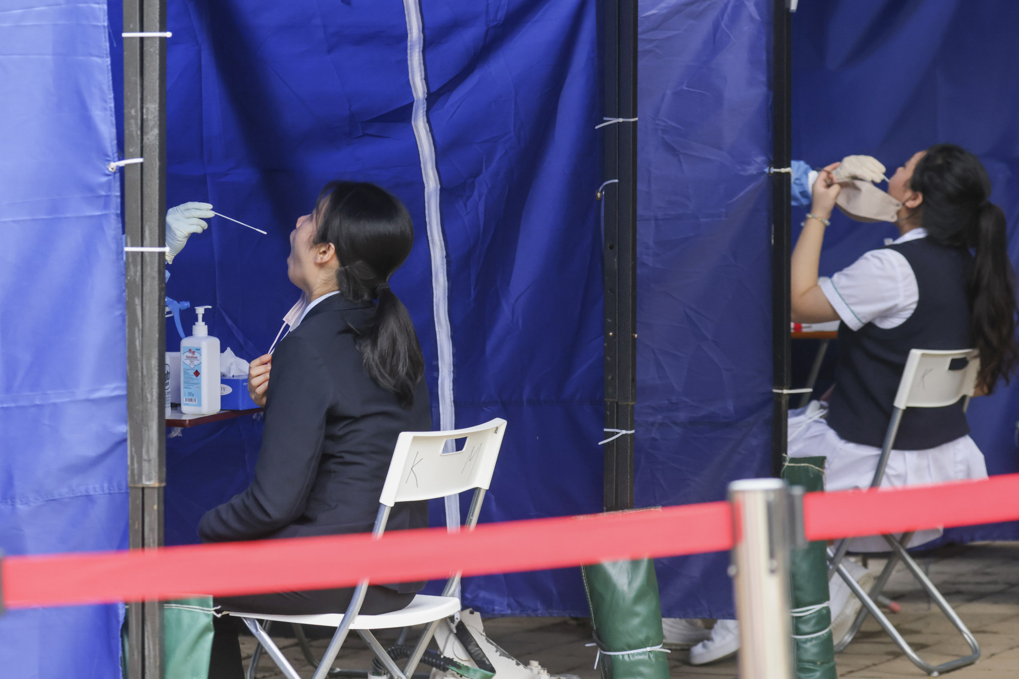 Residents undergoing screening for Covid-19 at a mobile specimen collection station as part of a compulsory testing order. Photo: Dickson Lee