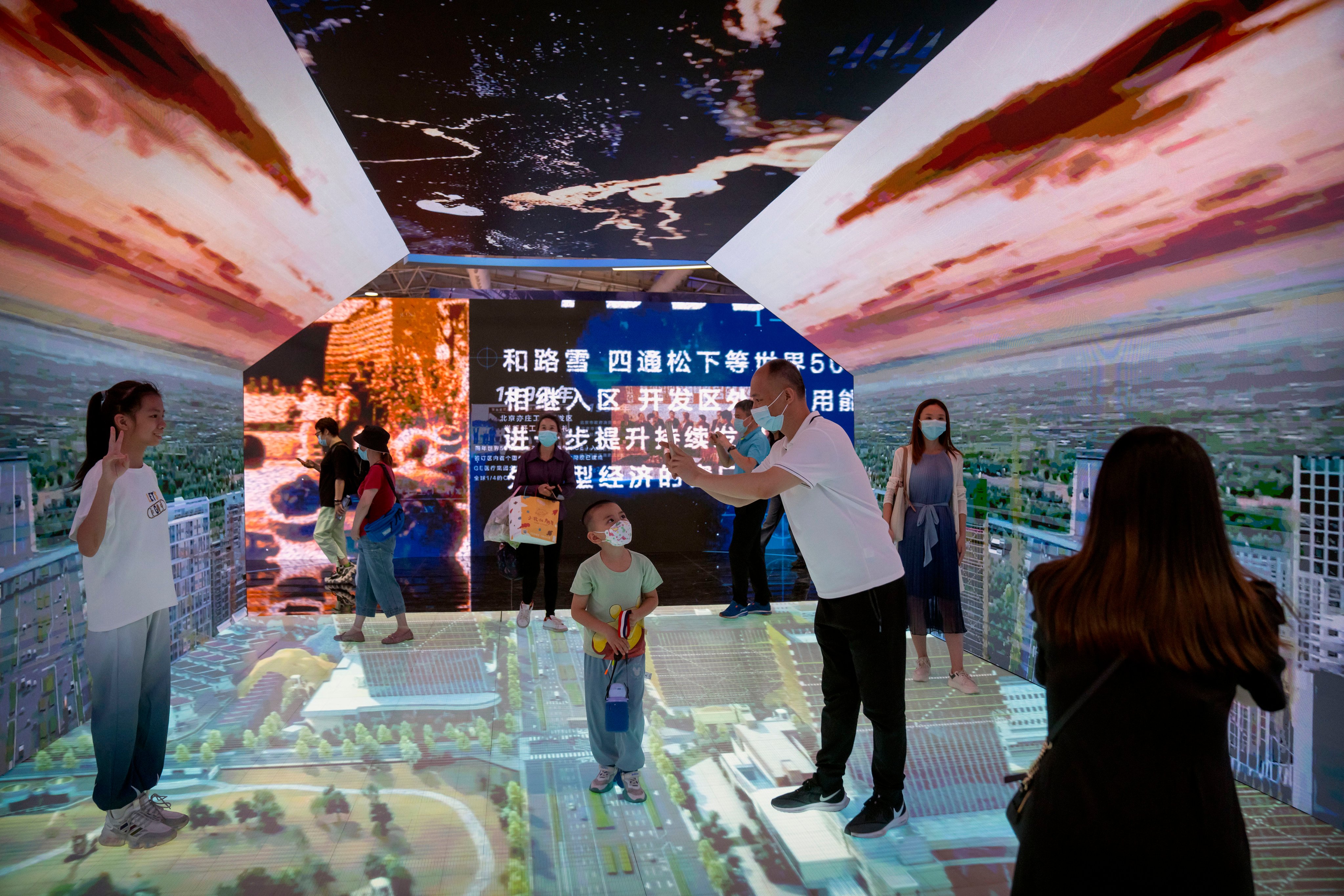Visitors walk through the Beijing E-town Metaverse Experience display at the China International Fair for Trade in Services on September 3. Photo: AP
