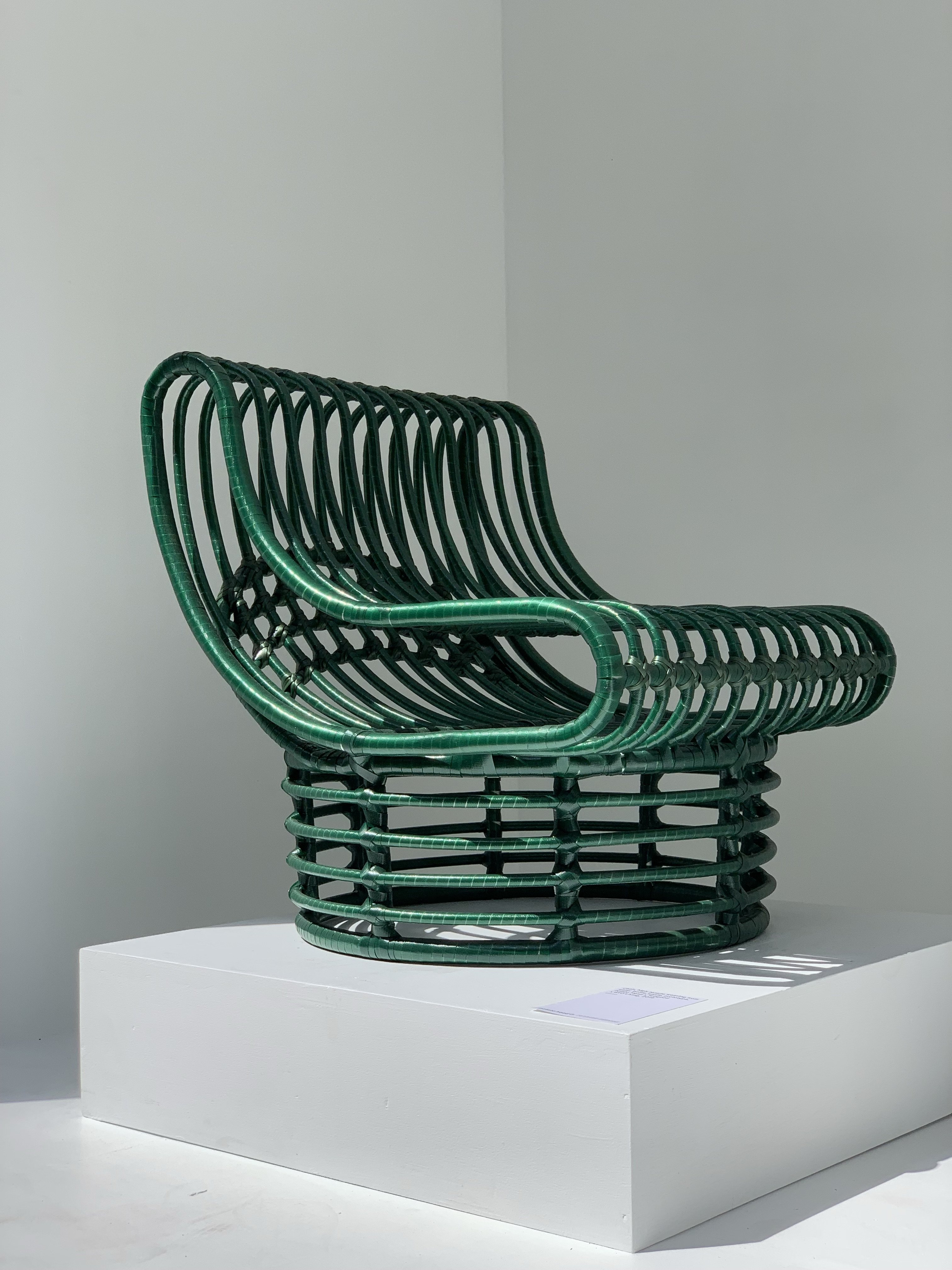 One of the woven green plastic chairs designed by TooGood and BYO Living. The chairs are each made with around 300 plastic bottles.