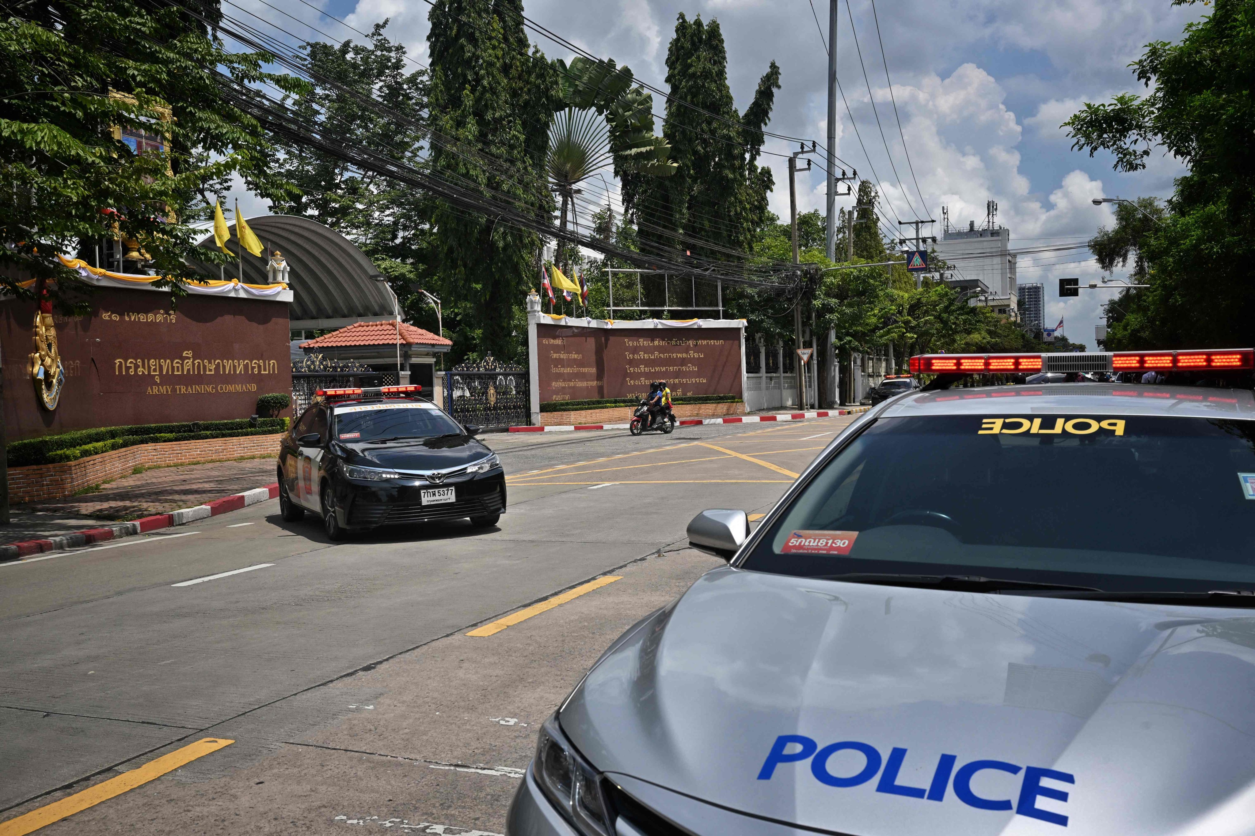 Police cars are seen parked outside the gates of the Royal Thai Army War College’s Army Training Command compound after Wednesday’s shooting. Photo: AFP