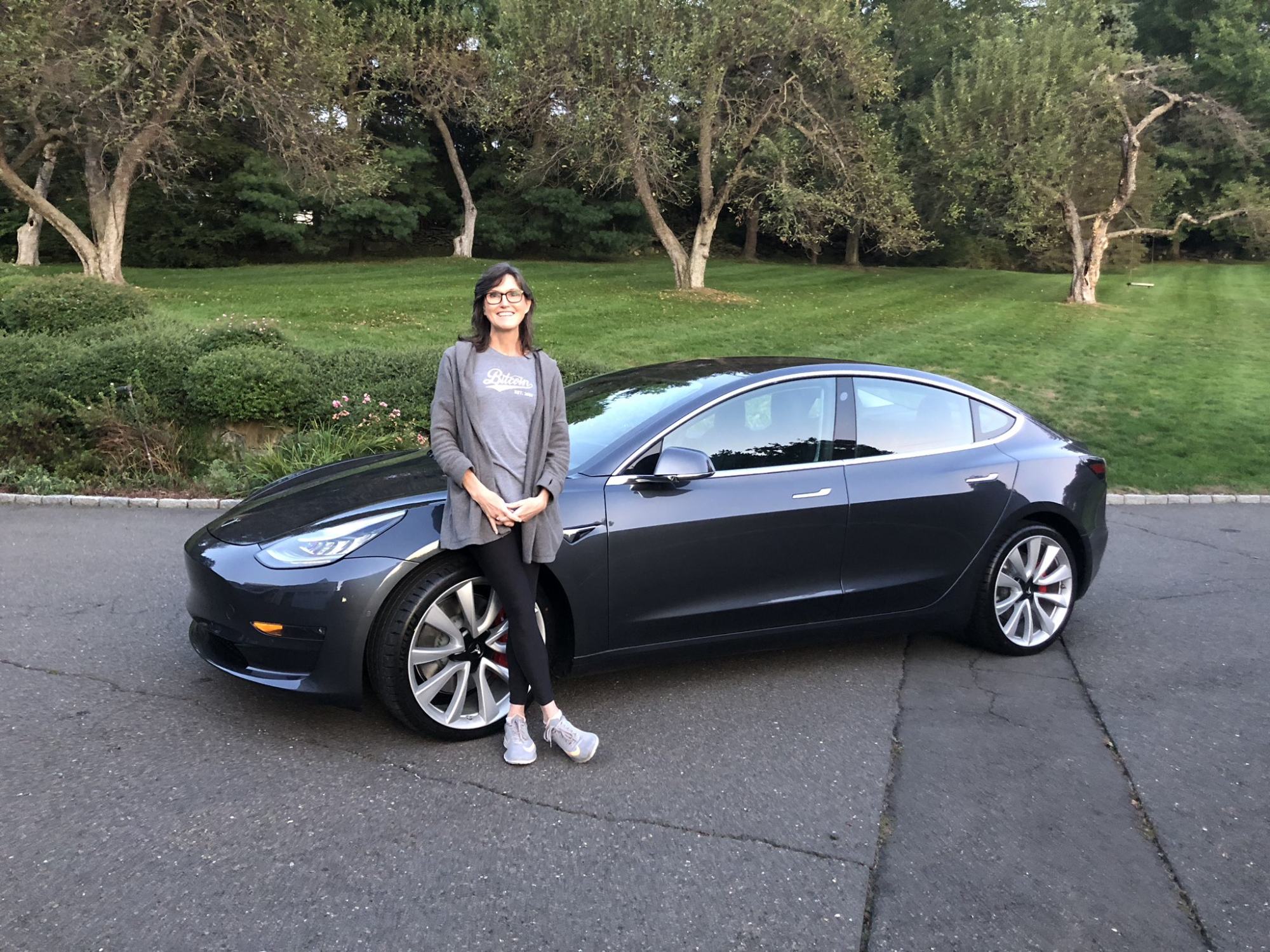 Cathie Wood and Tesla Model 3. She famously predicted that Tesla would be a US$3 trillion company. Photo: @CathieDWood/Twitter