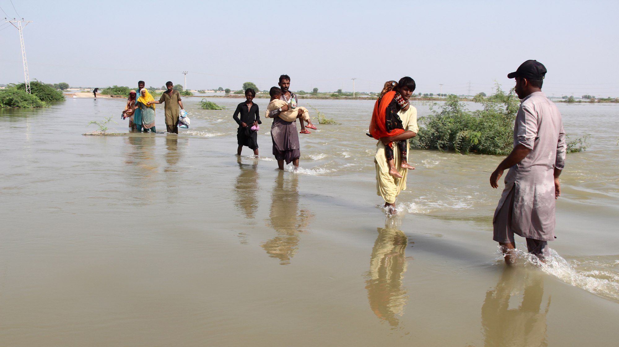 People affected by floods move to higher grounds in Jamshoro district, Sindh province, Pakistan earlier this month. Photo: EPA-EFE