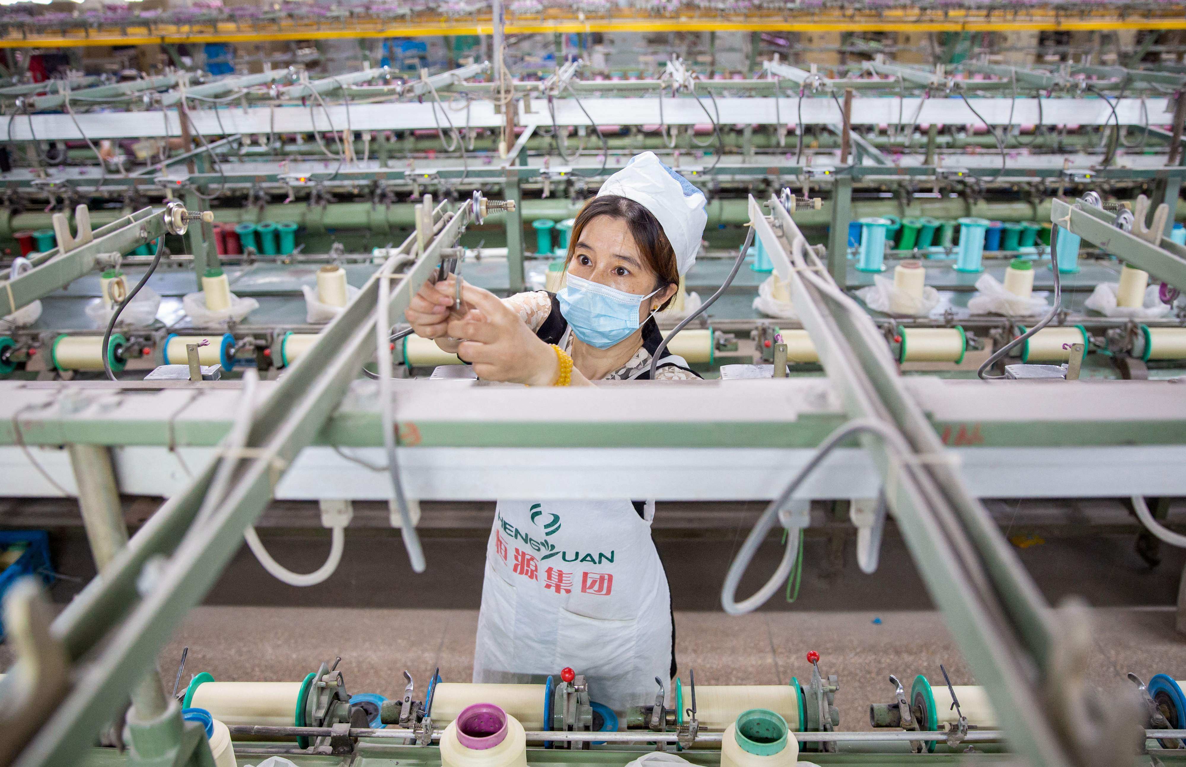 China’s manufacturers cut jobs for the fifth straight month to reduce costs in August. Photo: AFP