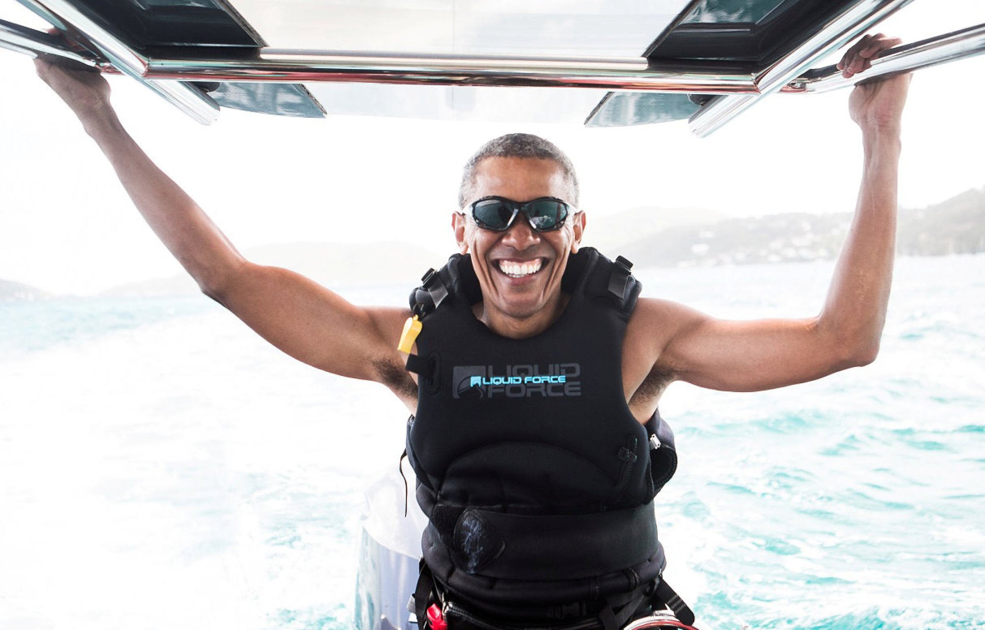 Former US President Barack Obama sits on a boat during a kite surfing outing with British businessman Richard Branson during his holiday in the British Virgin Islands, in February 2017. Photo: Reuters