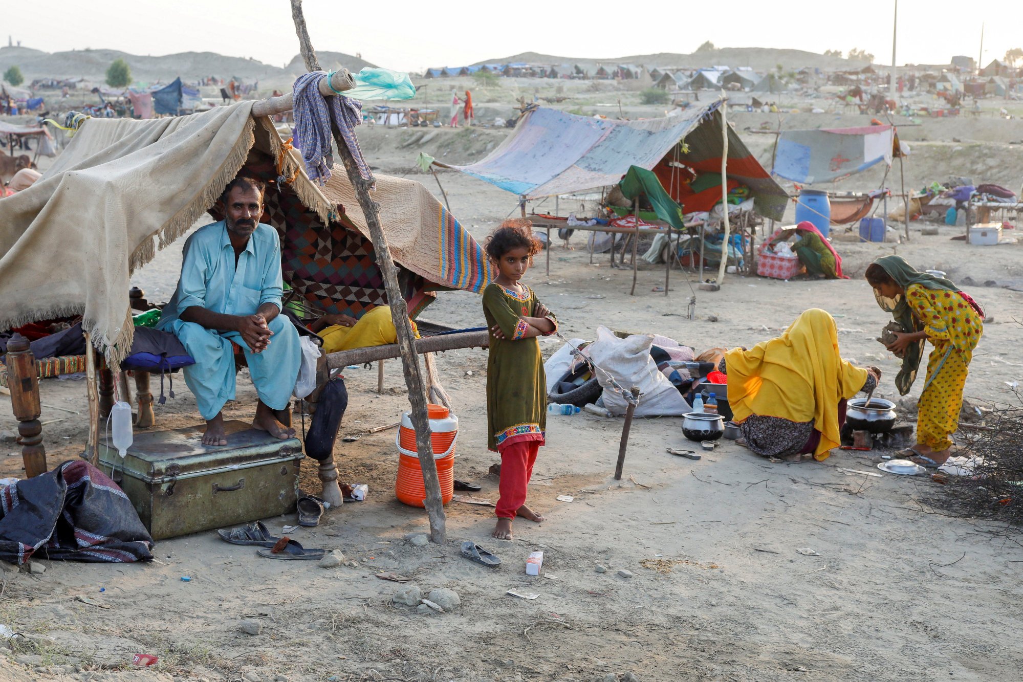 A family who became displaced take refuge in a camp, following rains and floods during the monsoon season in Sehwan, Pakistan. Over 1,325 people have died and 33 million displaced by the floods. Photo: Reuters