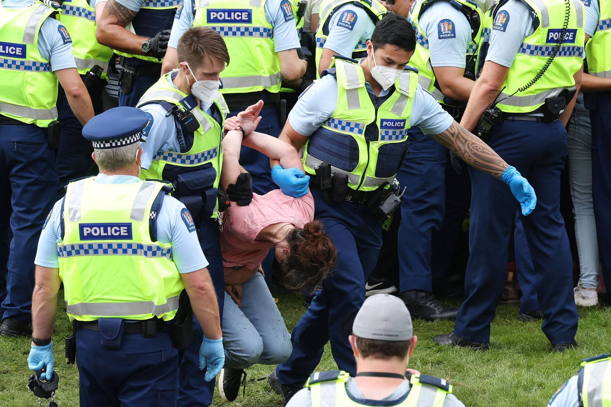 New Zealand police detain an anti-lockdown protester in Wellington in February. File photo: AFP