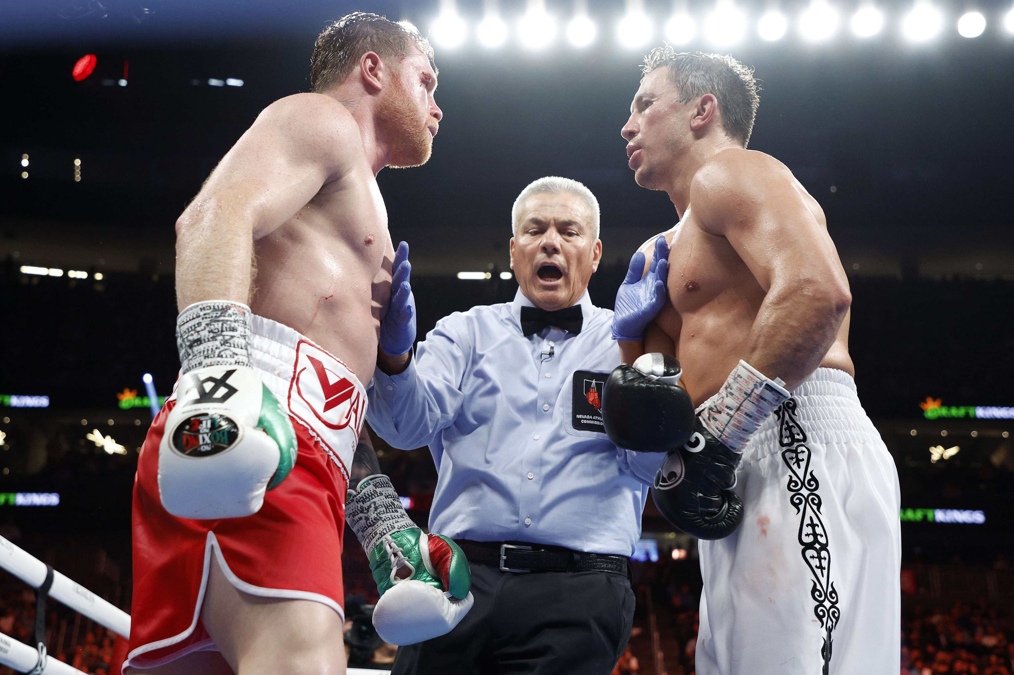 Canelo Alvarez (red trunks) and Gennadiy Golovkin (white trunks) square off following the eleventh round in Las Vegas. Photo: AFP