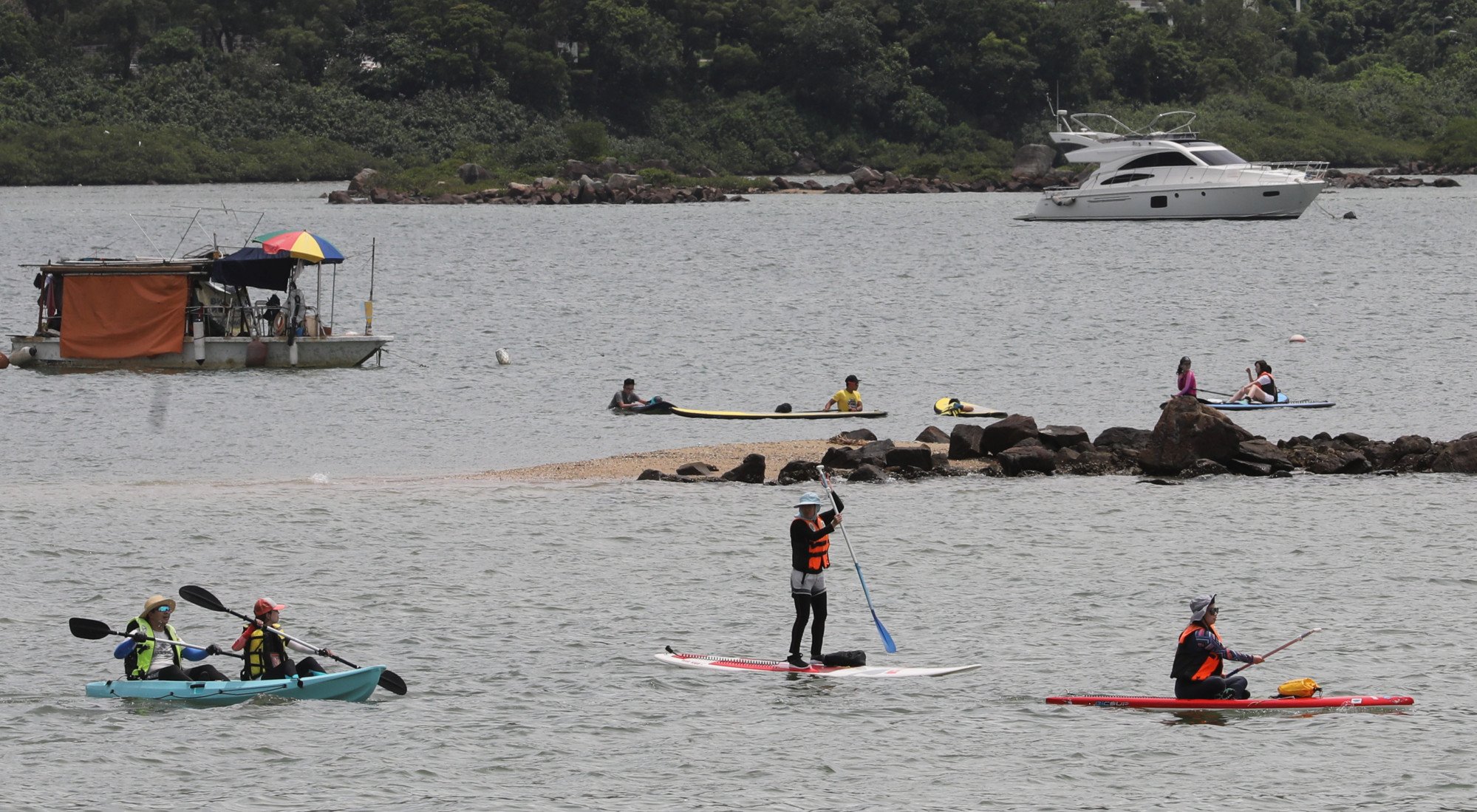 People enjoy canoeing and paddle boarding in better weather that Sunday’s. Photo: Dickson Lee.