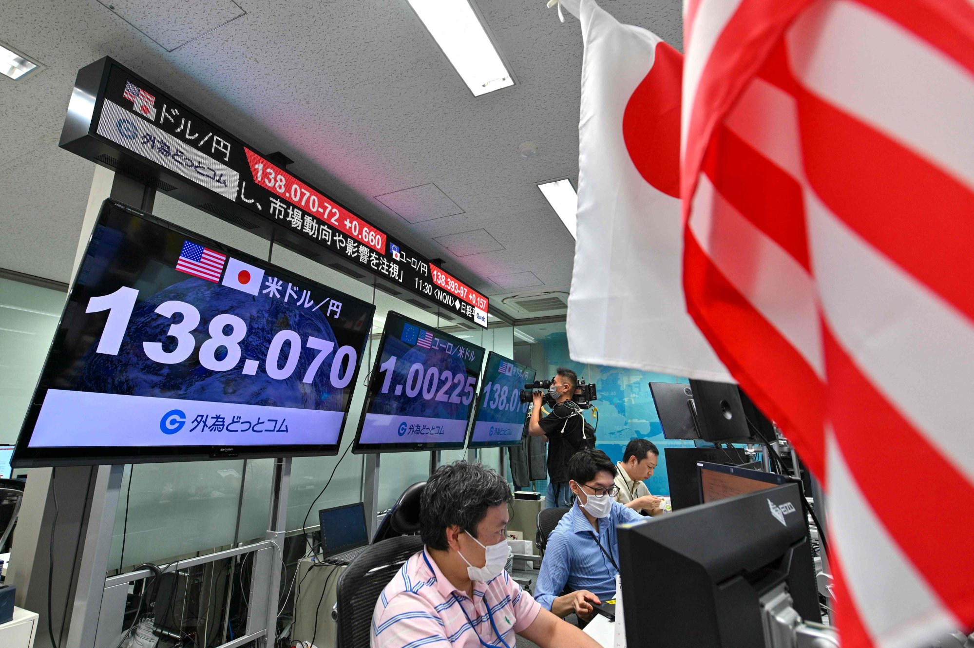 Electronic boards display the yen’s rate against the US dollar at a foreign exchange brokerage in Tokyo on July 14. Photo: AFP