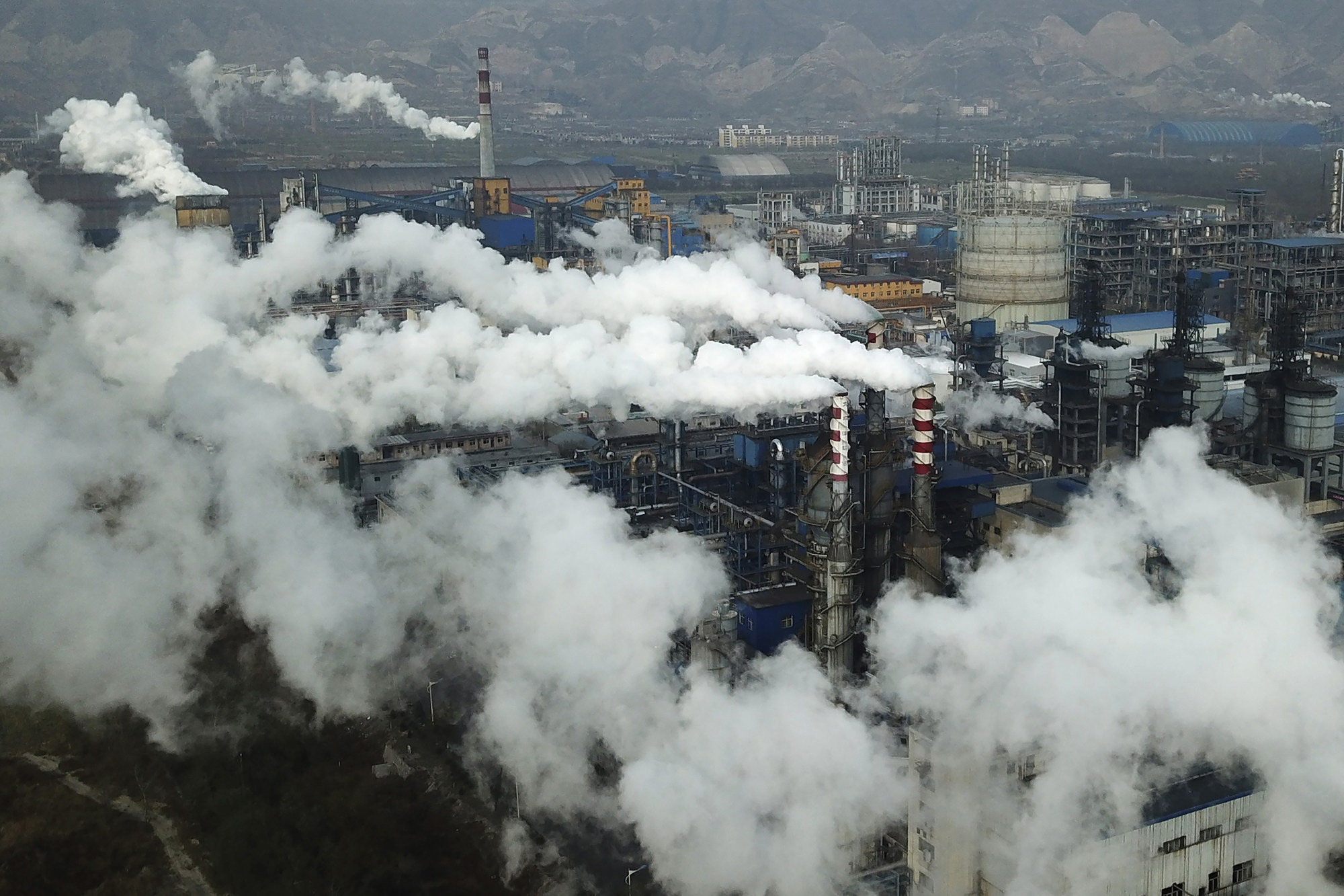 Smoke and steam rise from a coal processing plant in Hejin in central China’s Shanxi province. Photo: AP