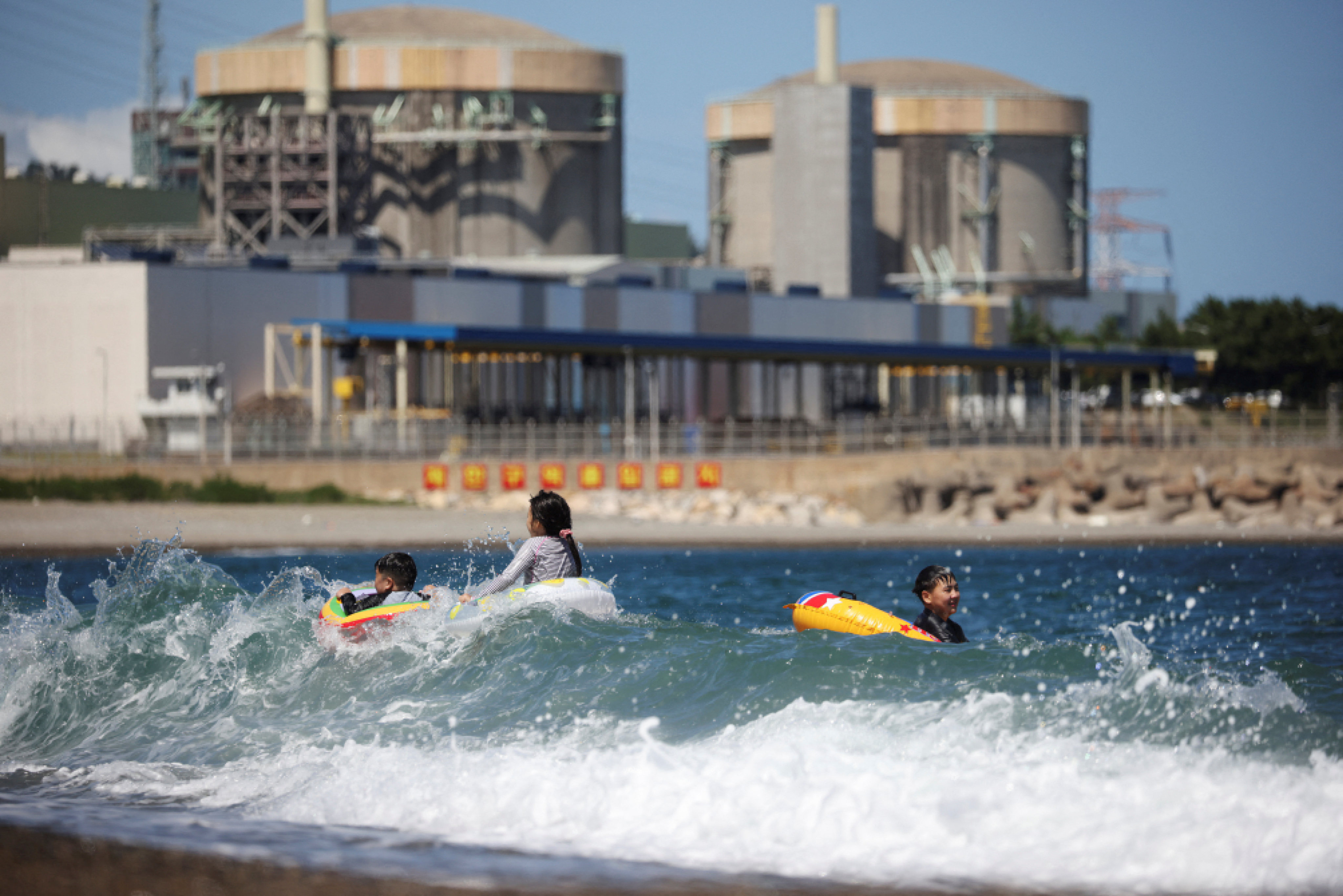Children play in the ocean near Wolseong Nuclear Power Plant in Gyeongju, South Korea, on August 21. Energy is the top concern for businesses in Asia, with rising prices driving up costs for firms even as countries such as Japan and South Korea move to embrace nuclear power. Photo: Reuters