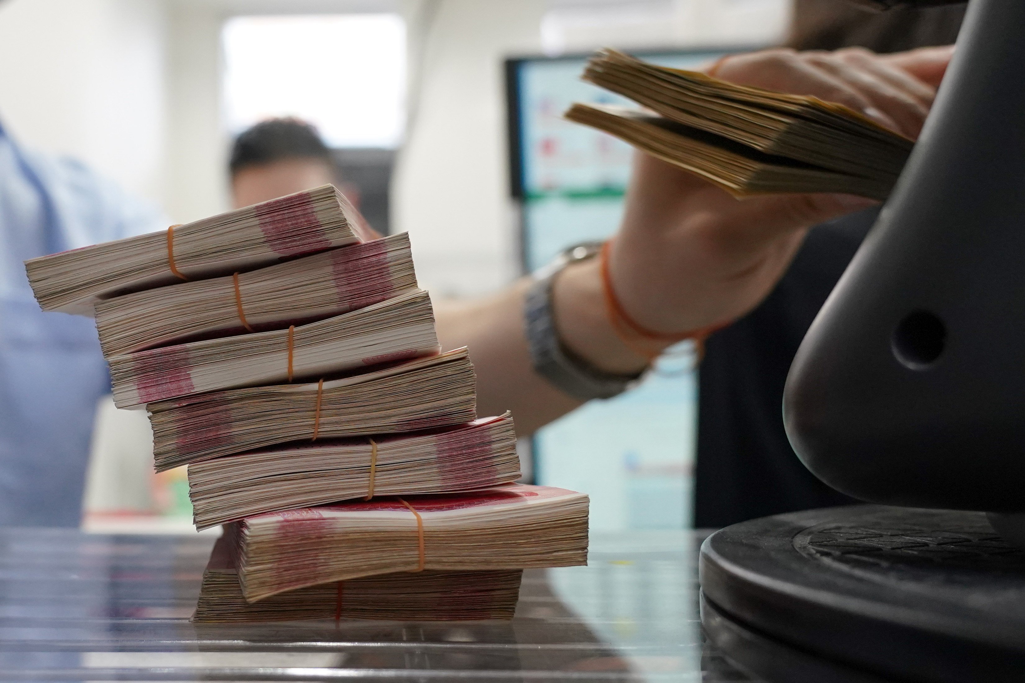 Chinese yuan banknotes are stacked up at a currency exchange in the Shinjuku district of Tokyo, Japan, on June 9. Photo: Bloomberg
