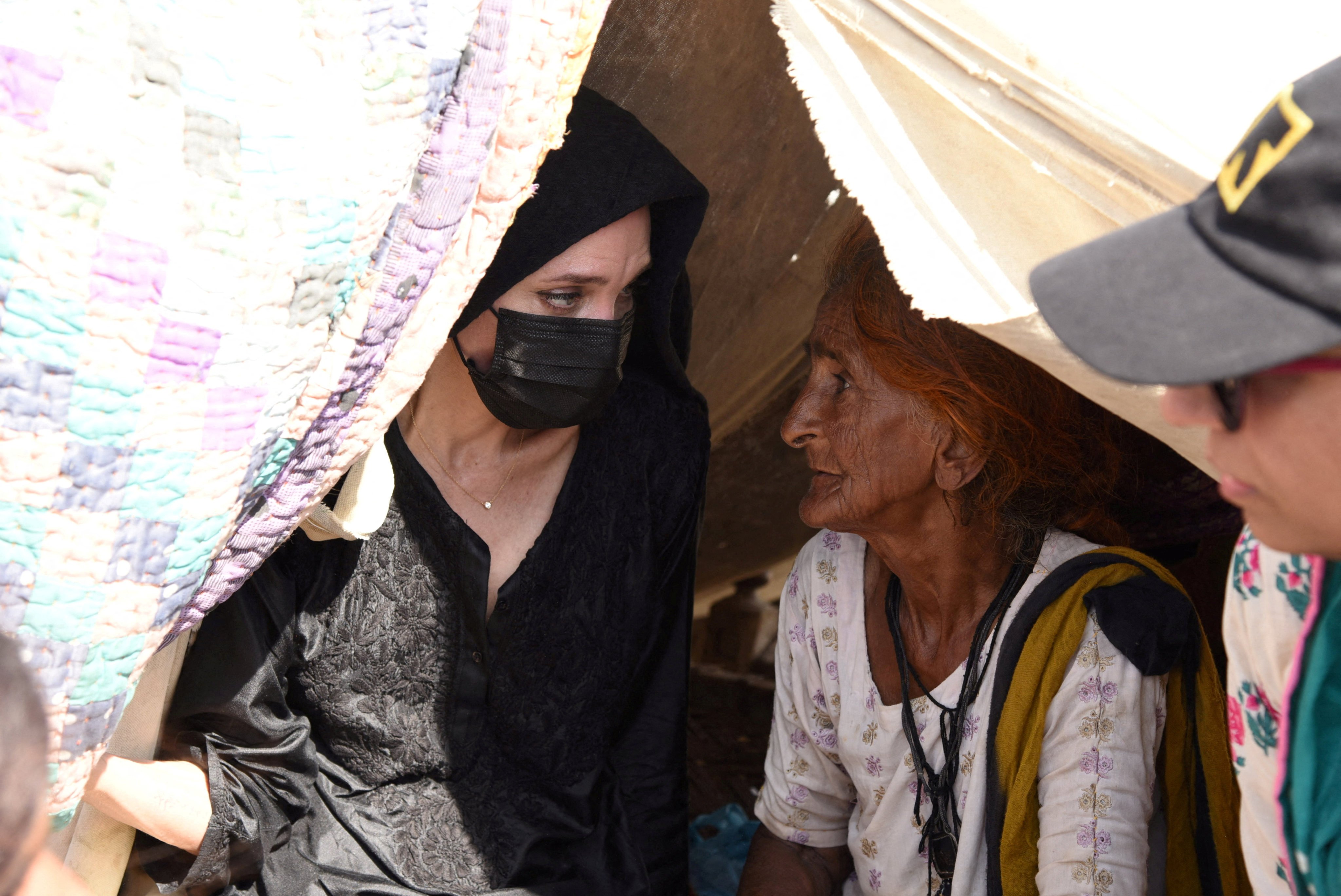 Angelina Jolie listens to a displaced woman in Dadu, Pakistan, on Tuesday following devastating rains and floods. Photo: Saima Javaid/IRC Handout via Reuters