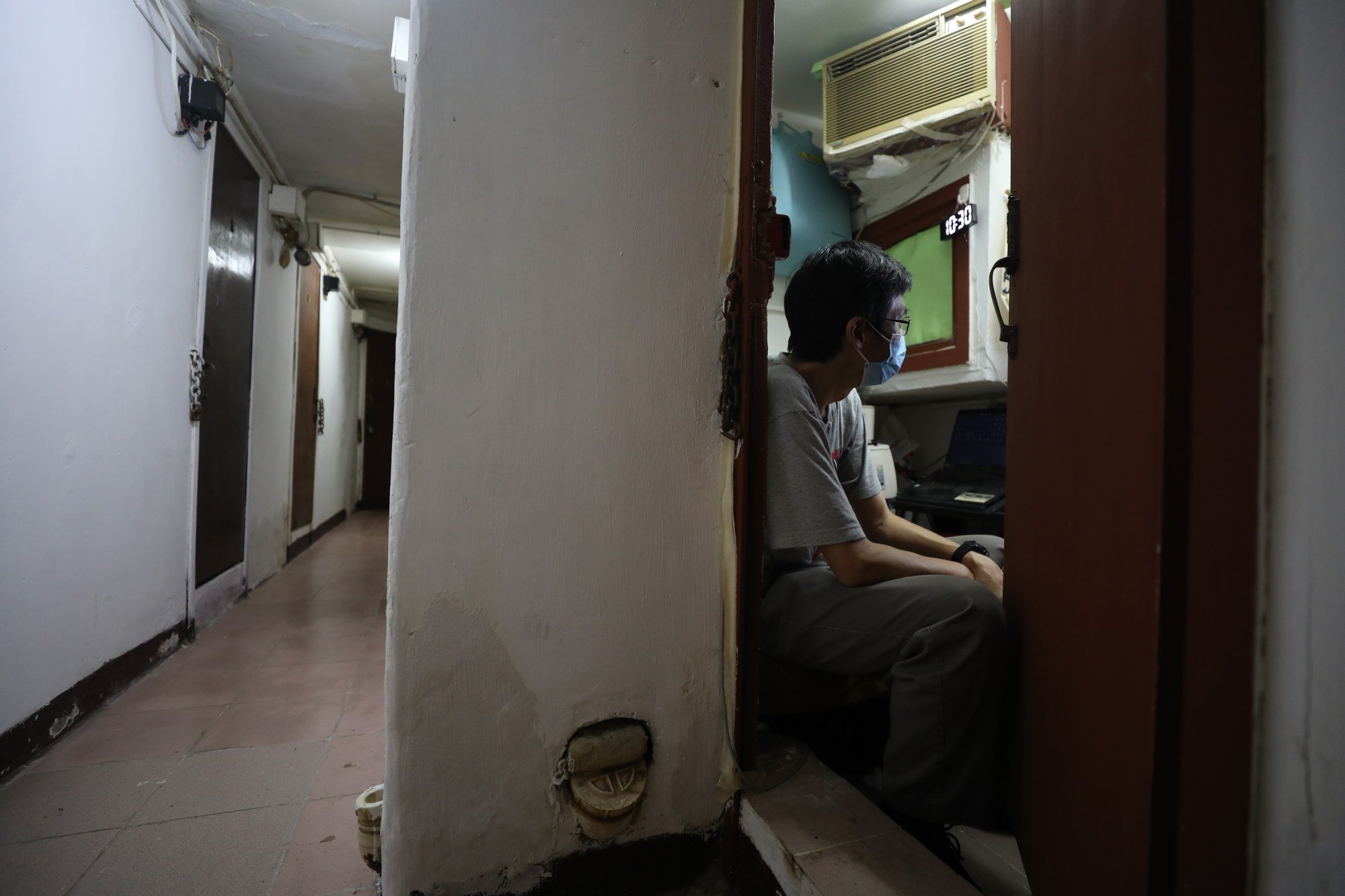 A resident at his subdivided flat in Sham Shui Po. Photo: Xiaomei Chen